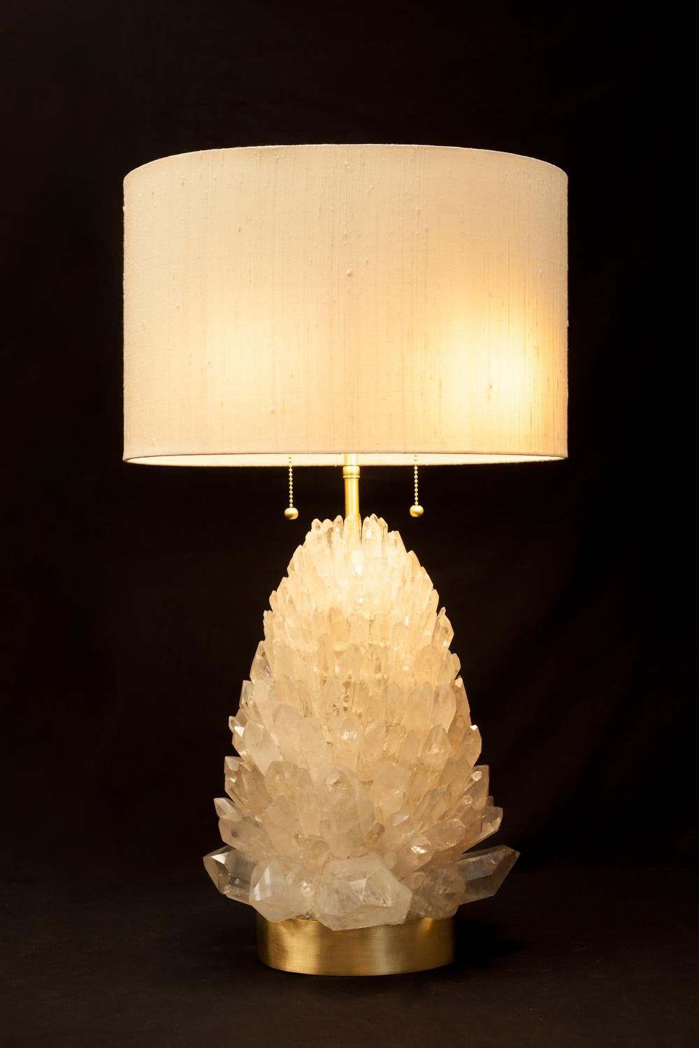 Natural rock crystal table lamp, signed by Demian Quincke.
Natural rock crystal assembled and sculpted on brass base.
Dimensions: 70 x 30 x 26 cm.

Brass 2lt.cluster with large body, includes pull chain sockets, swivels, body.
top adjustable