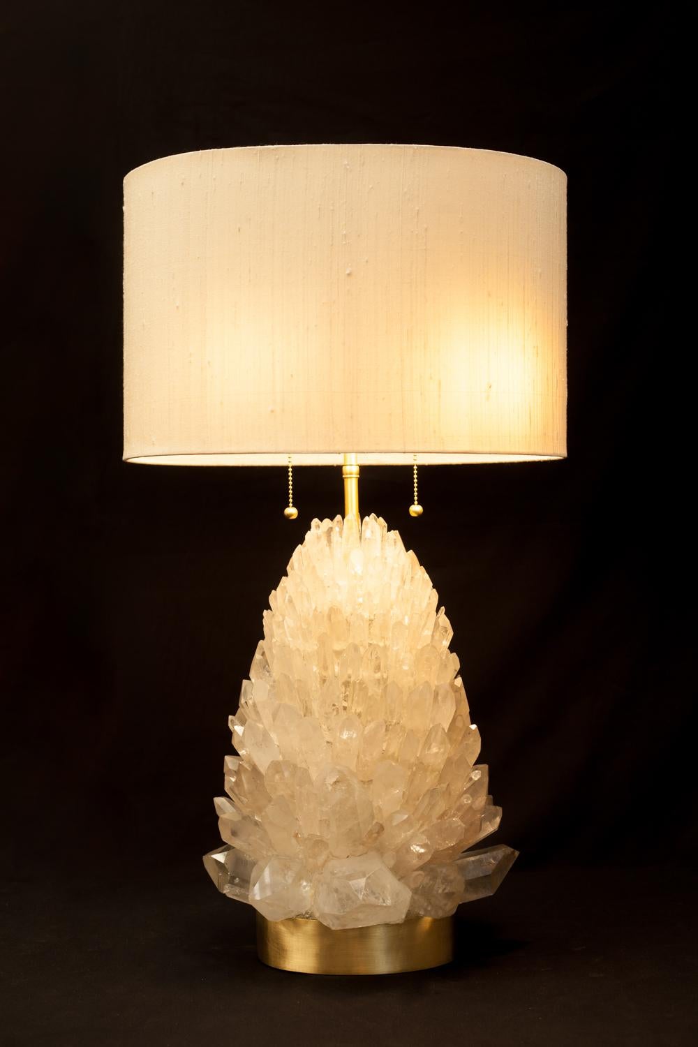 Natural rock crystal table lamp, signed by Demian Quincke.
Natural rock crystal assembled and sculpted on brass base.
Dimensions: 70 x 30 x 26 cm.

Brass 2lt.cluster with large body, includes pull chain sockets, swivels, body.
top adjustable