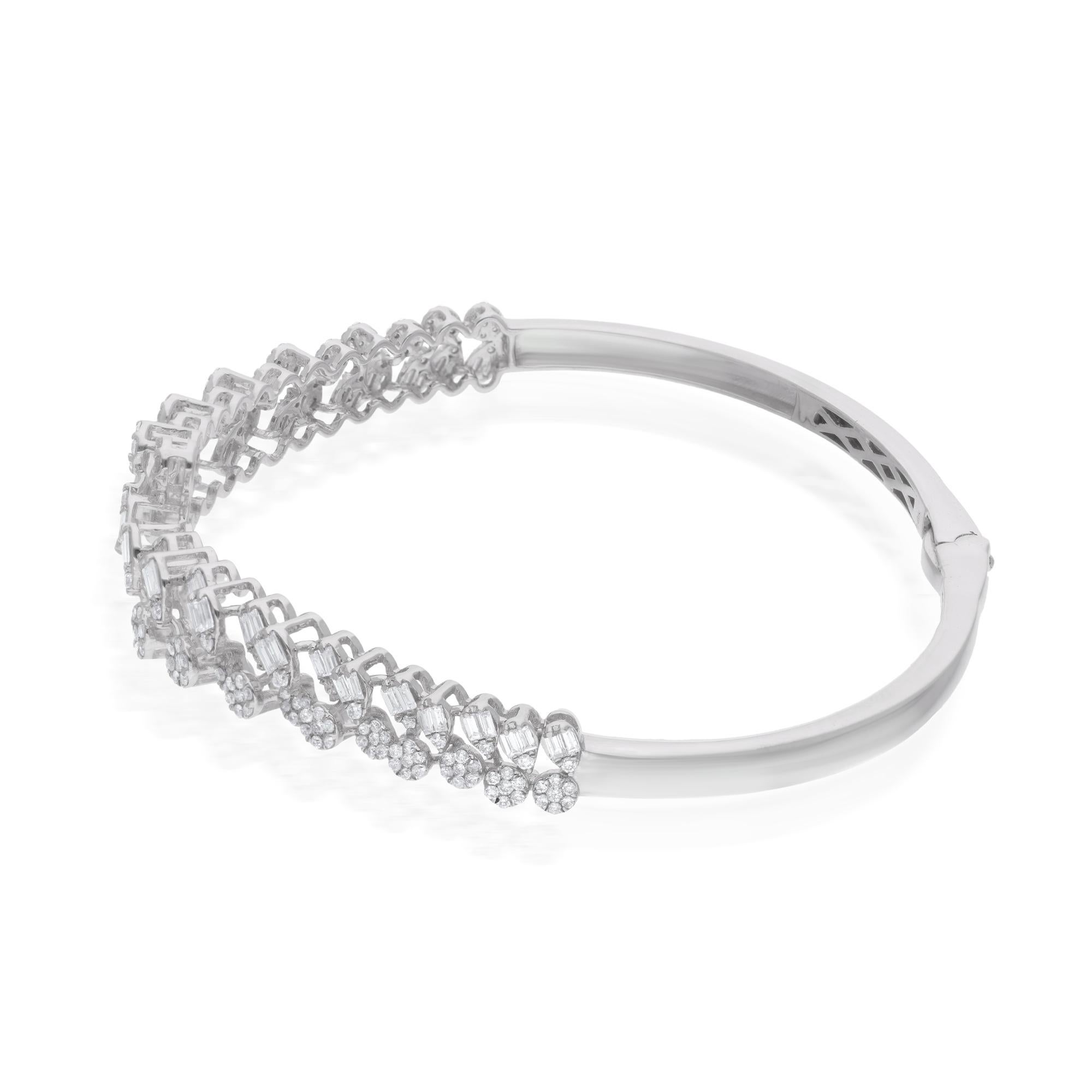 At the heart of the bracelet lies a breathtaking array of natural round and baguette diamonds, meticulously set to create a mesmerizing tapestry of sparkle and shine. The round diamonds, with their classic brilliance, exude a sense of timeless