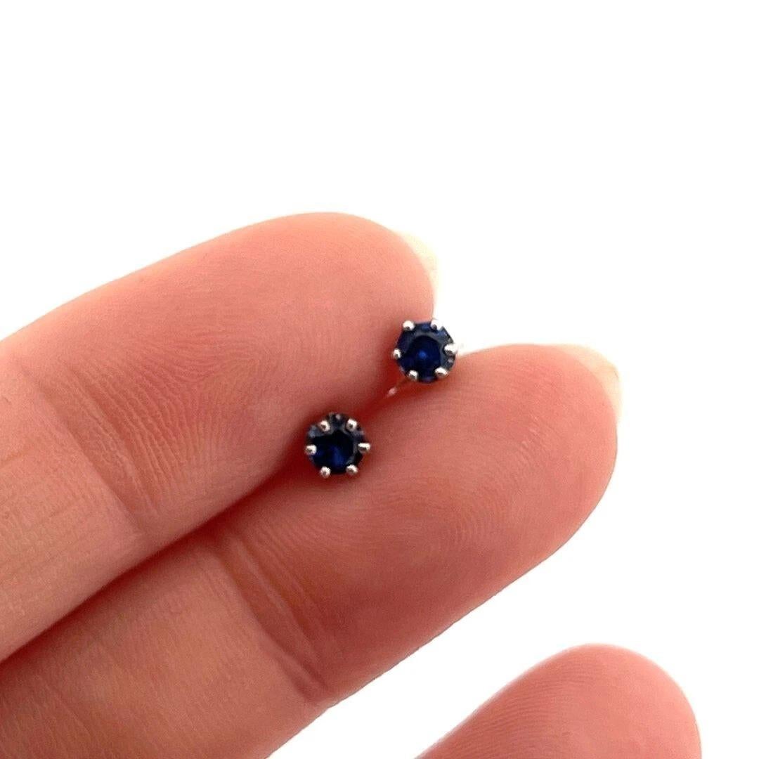 These elegant sapphire stud earrings feature two round faceted sapphires measuring approximately 3.50mm each, displaying a very fine royal blue hue. The gemstones are set in secure 6-prong low-profile crown basket settings crafted in solid 14 karat