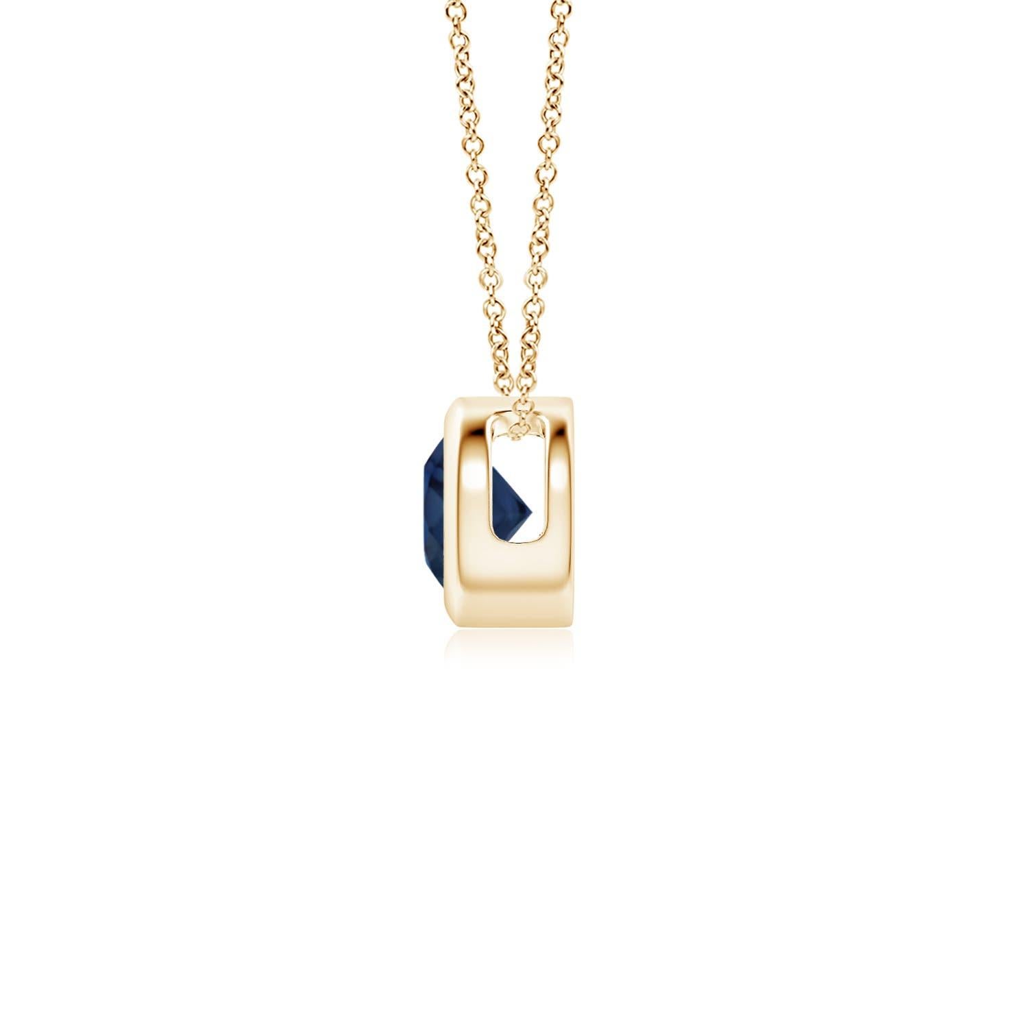 This classic solitaire sapphire pendant's beautiful design makes the center stone appear like it's floating on the chain. The radiant blue gem is secured in a bezel setting. Crafted in 14k yellow gold, this round sapphire pendant is simple yet