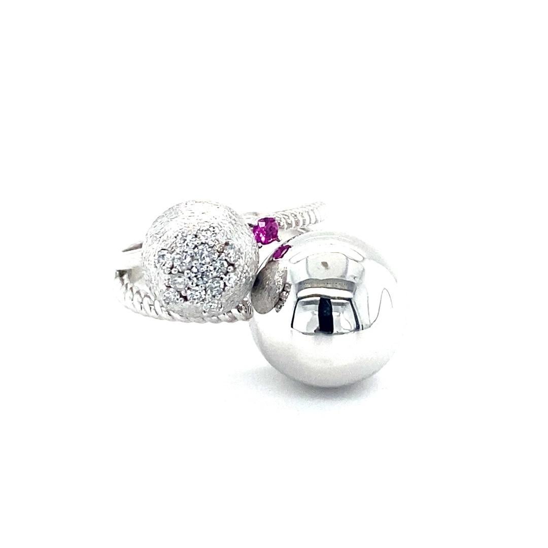 Diamond and Pink Sapphire White Gold Cocktail Ring
Super unique cocktail ring!!

Item Specs:
14 Natural Round Cut Diamonds = 0.20 carats (Clarity: SI2, Color: F)
1 Natural Round Cut Pink Sapphire = 0.06 carats
14K White Gold = 9.4 grams
Ring size =