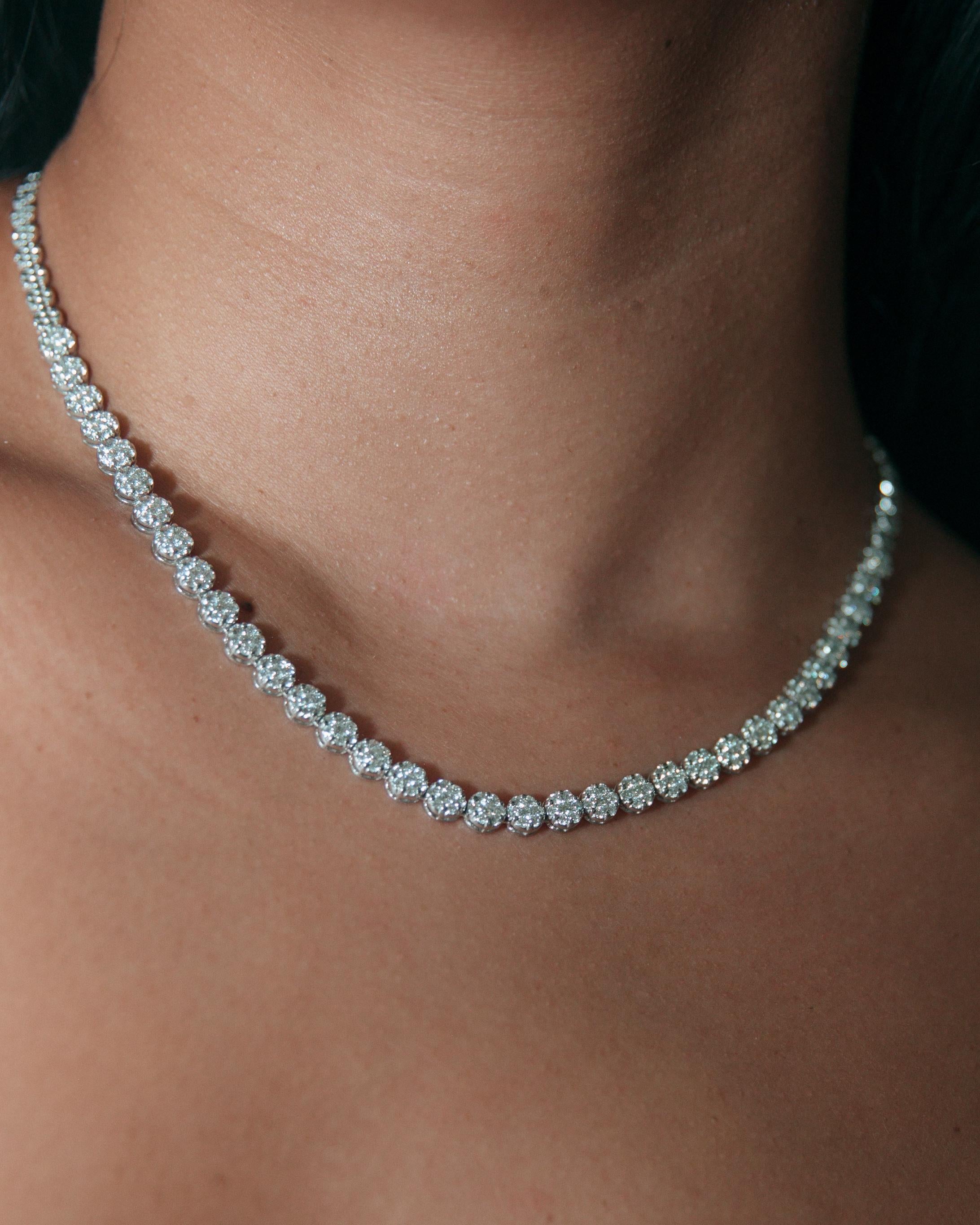 Make a statement with this luxurious 4.61ct t.w. diamond statement invisible set tennis necklace. Boasting a timeless floral design, this dazzling piece is sure to make a lasting impression.

Product Details:

272 Round Brilliant Diamond

Total