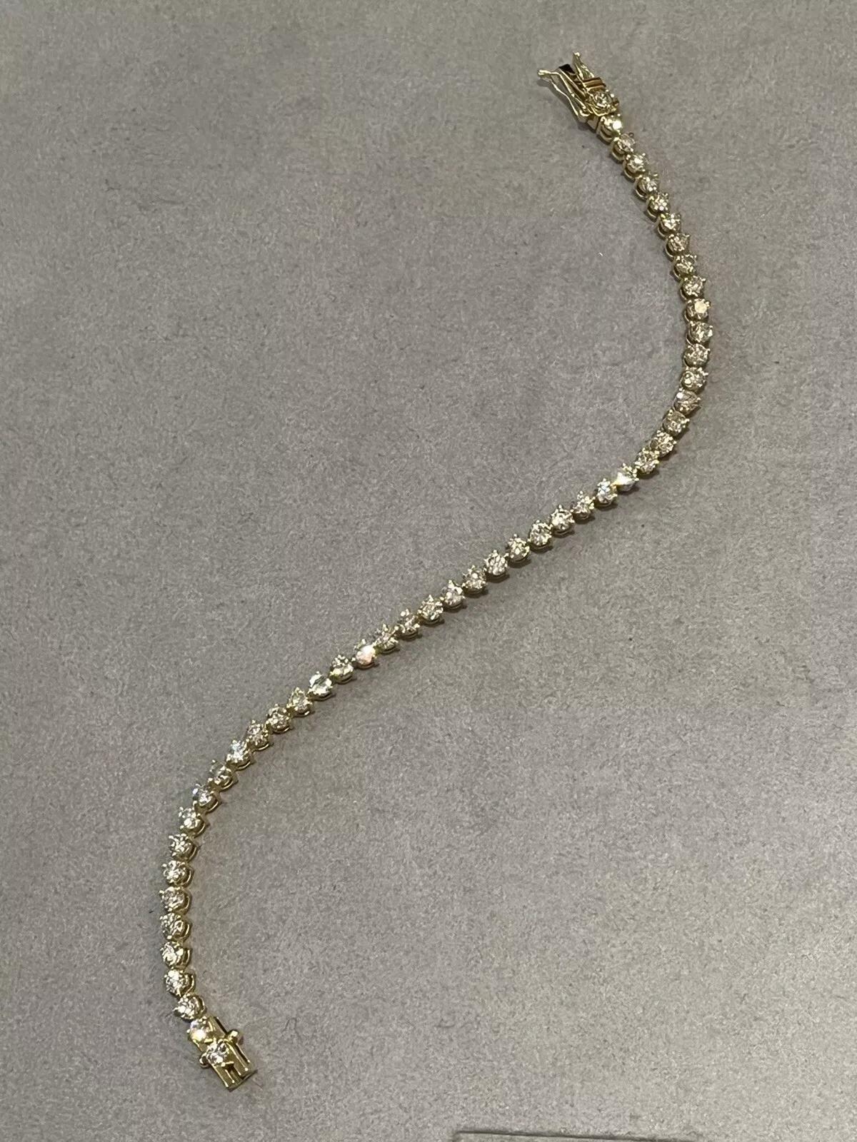 Natural Round Diamond Tennis Bracelet 4.91 cttw in 18k Yellow Gold

Diamond Tennis Bracelet features 49 Round Brilliant Diamonds, weighing 4.91 carats in total, all set in 18k Yellow Gold. The bracelet is secured by a box clasp with two