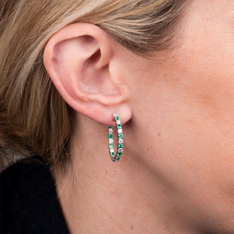 These are not your ordinary hoop earrings.  They feature 1.02 carat total weight in round natural emeralds alternating with 1.00 carat total weight in round natural diamonds set in 14 karat white gold. 
Measurements: Inner diameter approximately 20mm