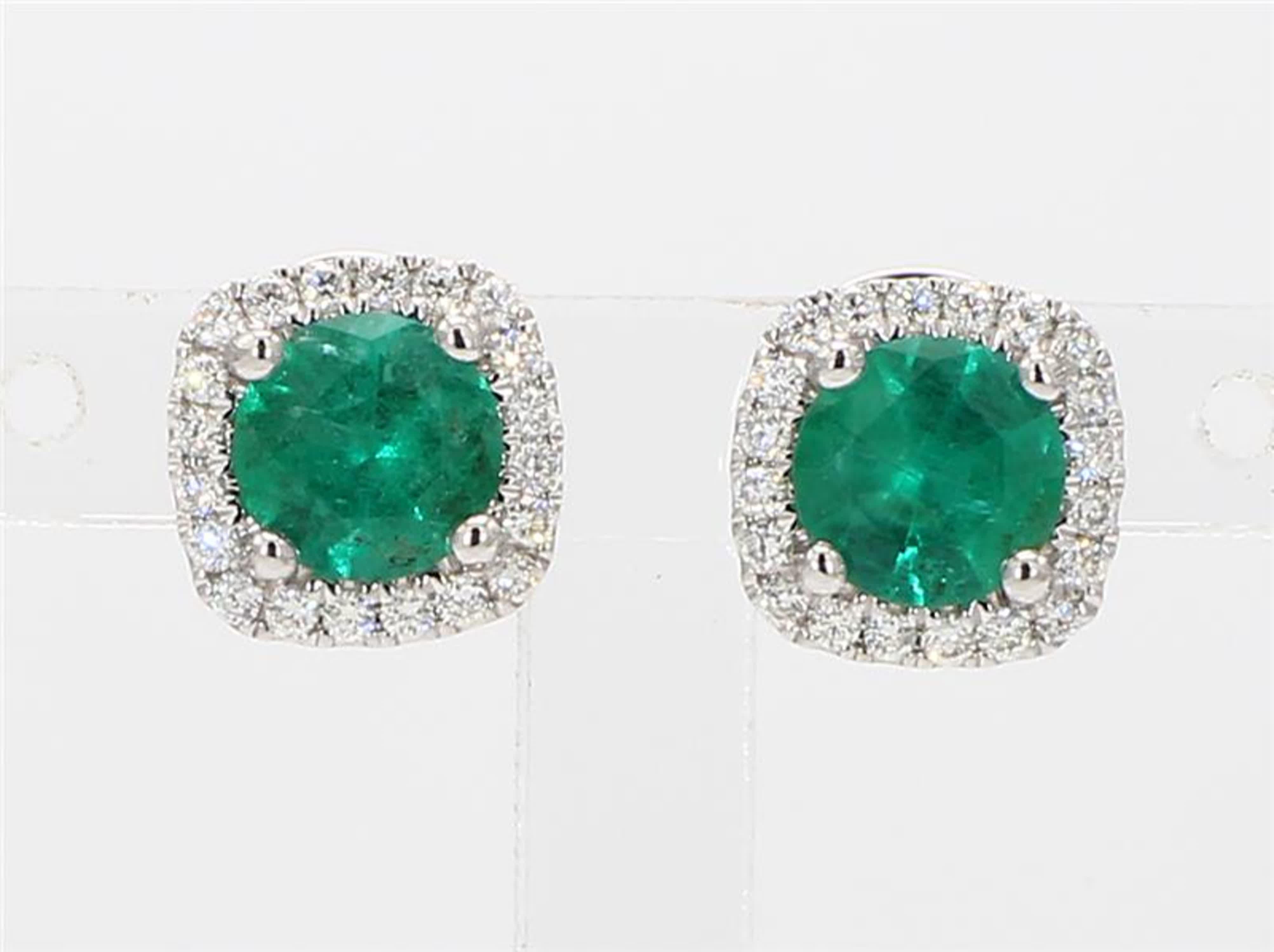 RareGemWorld's classic emerald earrings. Mounted in a beautiful 14K White Gold setting with natural round cut green emerald's. The emerald's are surrounded by natural round white diamond melee. These earrings are guaranteed to impress and enhance