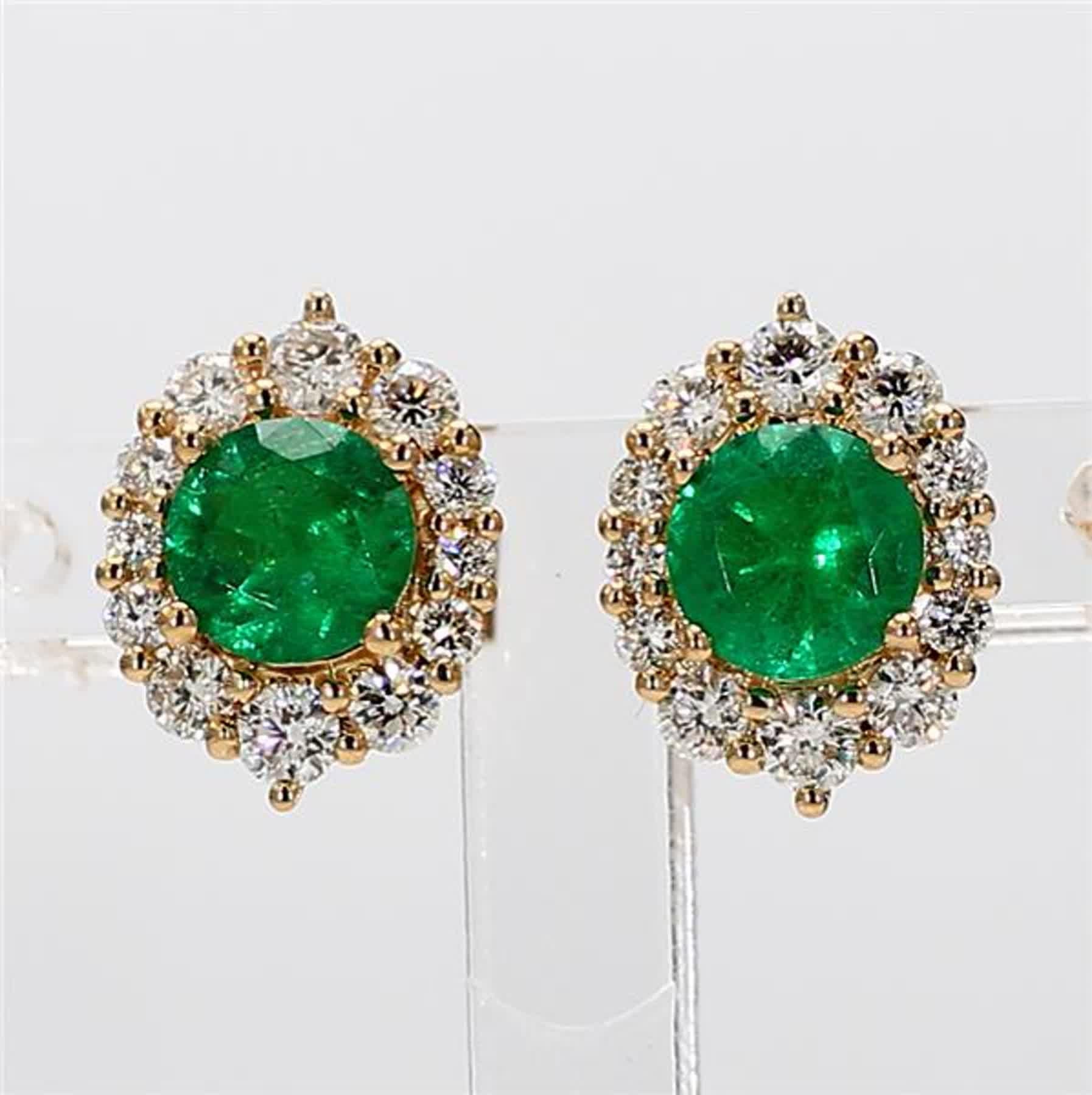 RareGemWorld's classic natural round cut emerald earrings. Mounted in a beautiful 14K Yellow Gold setting with natural round cut green emerald's. The emerald's are surrounded by natural round white diamond melee in a beautiful single halo. These