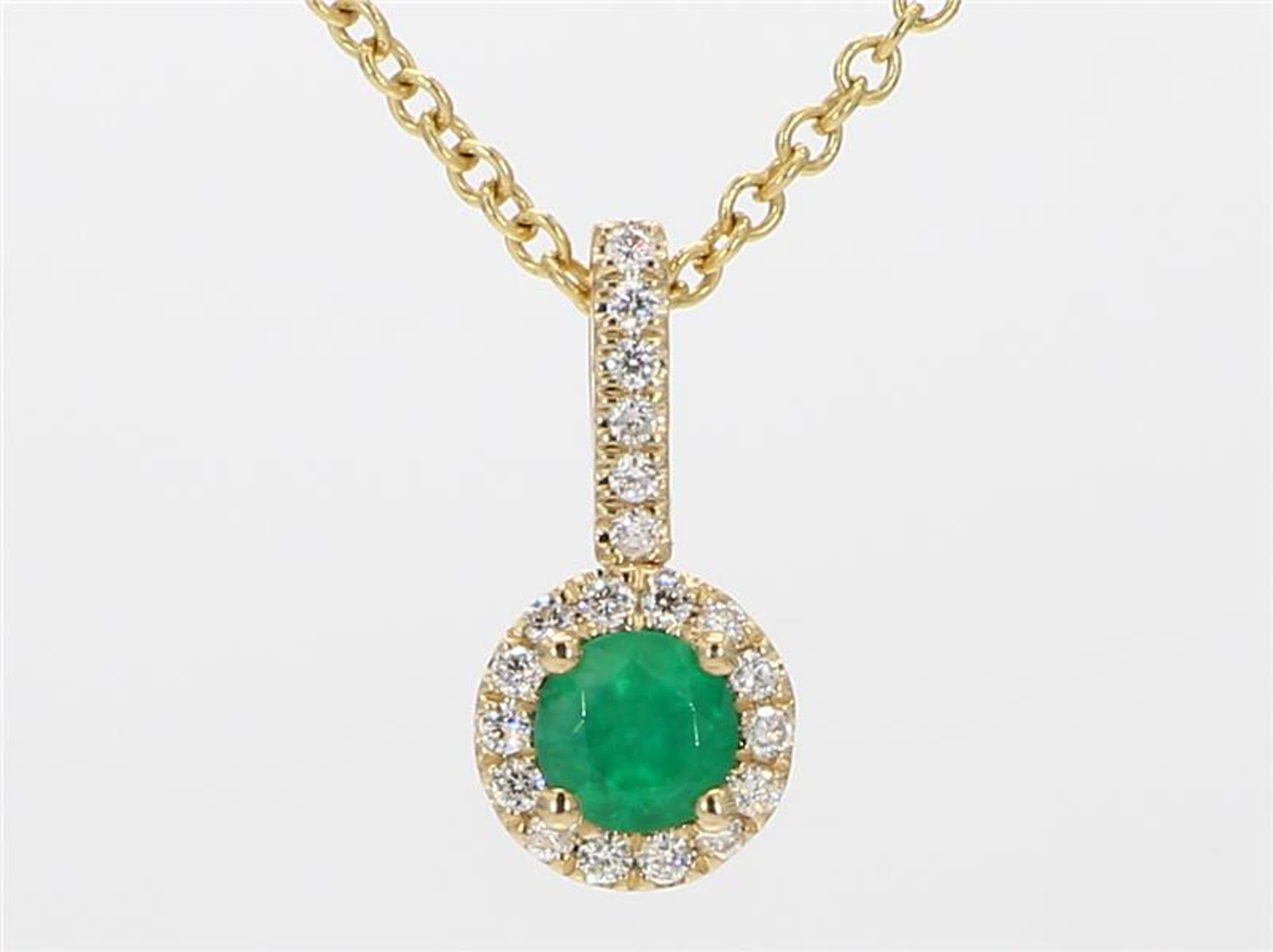 RareGemWorld's classic emerald pendant. Mounted in a beautiful 14K Yellow Gold setting with a natural round cut emerald. The emerald is surrounded by natural round white diamond melee in a beautiful single halo as well as continuing on the bell of