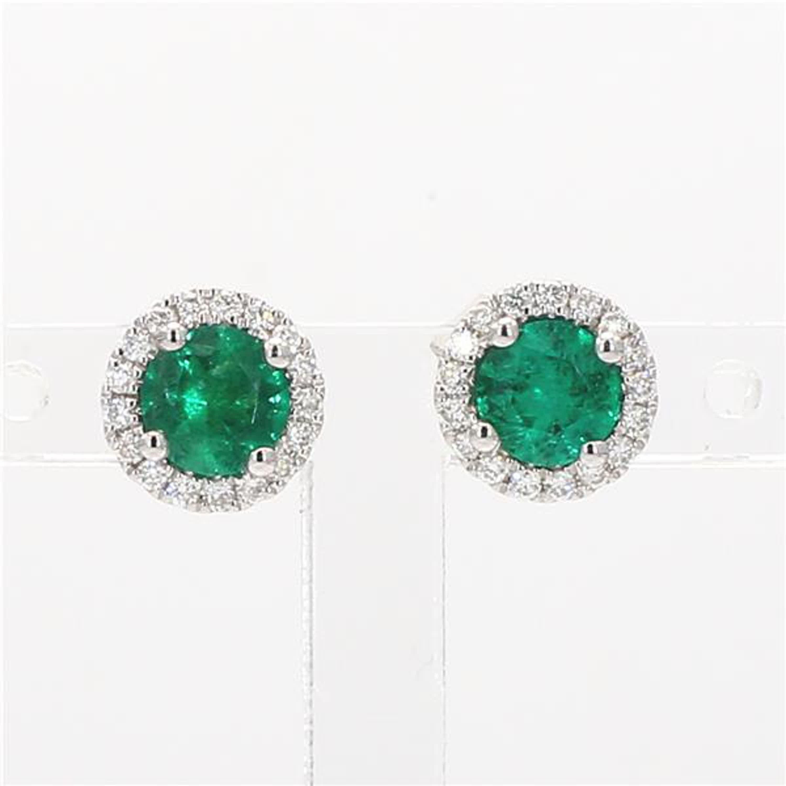 RareGemWorld's classic emerald earrings. Mounted in a beautiful 14K White Gold setting with natural round cut green emerald's. The emerald's are surrounded by natural round white diamond melee in a beautiful single halo. These earrings are