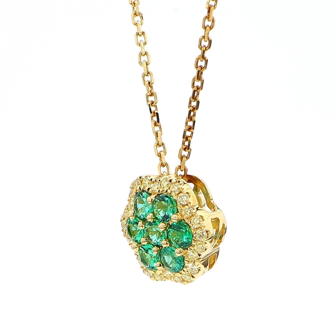 RareGemWorld's beautiful emerald pendant. Mounted in a beautiful 18K Yellow Gold setting with natural round cut emerald's. The emerald's are surrounded by natural round yellow diamond melee. This pendant is guaranteed to impress and enhance your