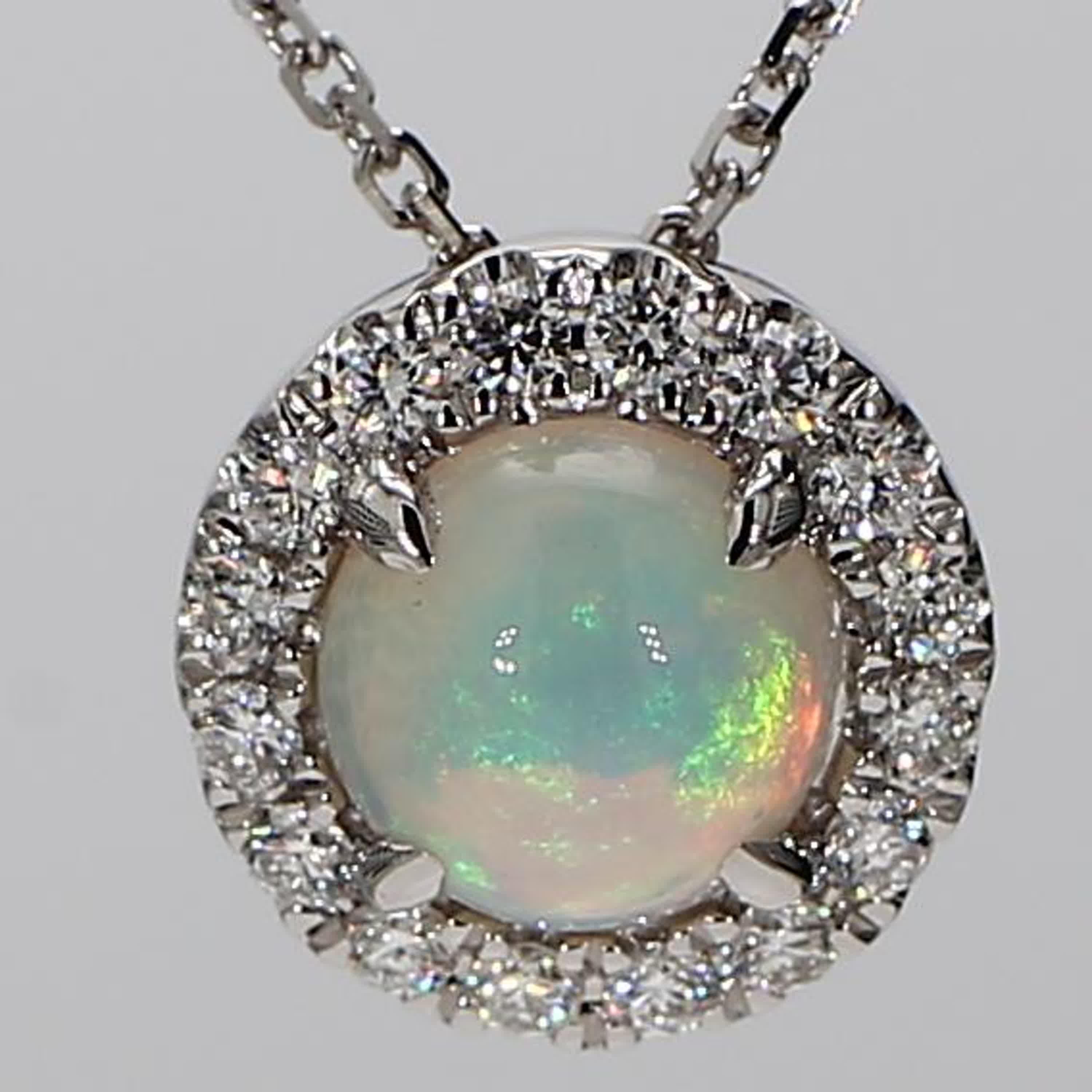 RareGemWorld's classic opal pendant. Mounted in a beautiful 18K White Gold setting with a natural round cut opal. The opal is surrounded by natural round white diamond melee in a beautiful single halo. This pendant is guaranteed to impress and