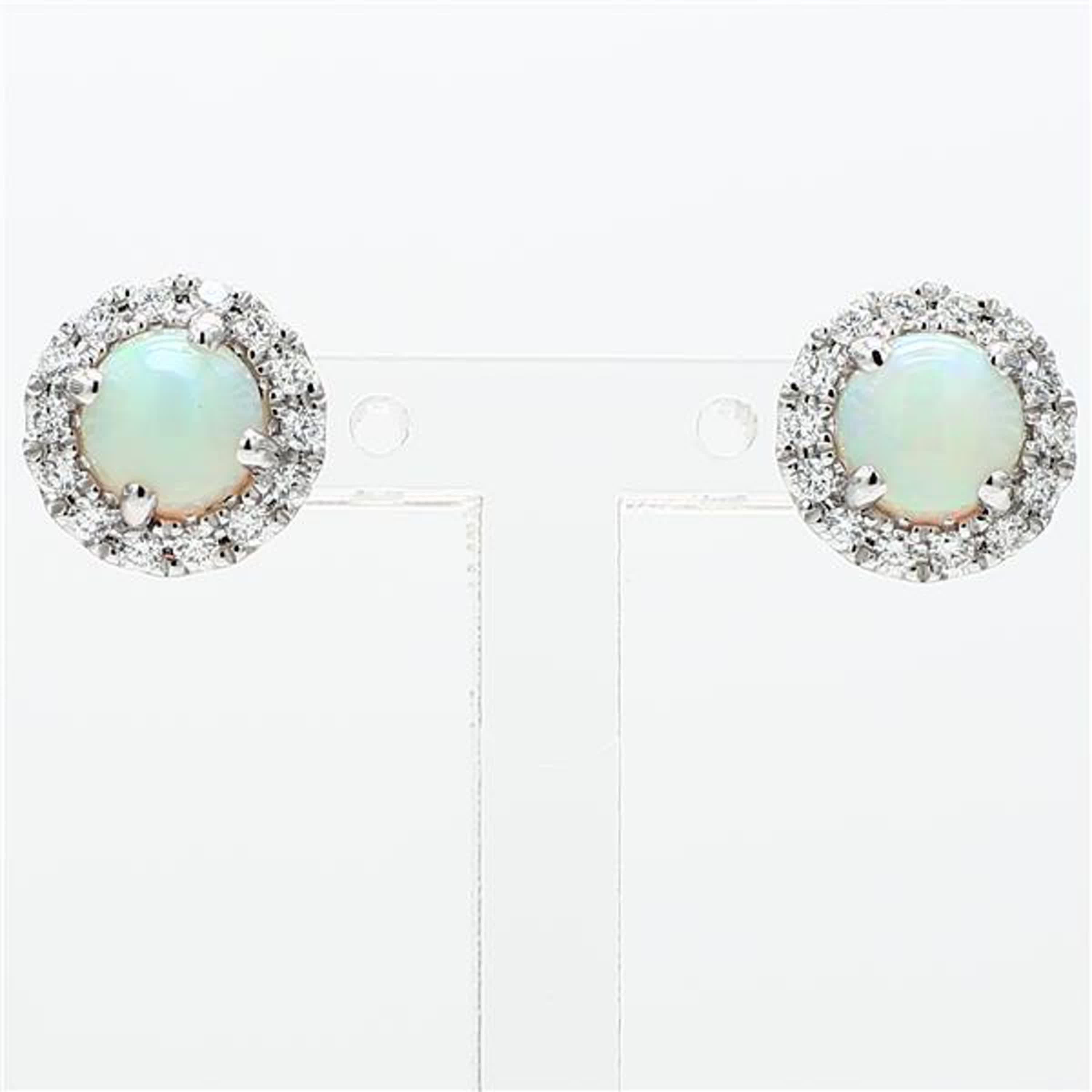 RareGemWorld's classic opal earrings. Mounted in a beautiful 14K White Gold setting with natural round cut opal's. The opal's are surrounded by natural round white diamond melee in a beautiful single halo. These earrings are guaranteed to impress