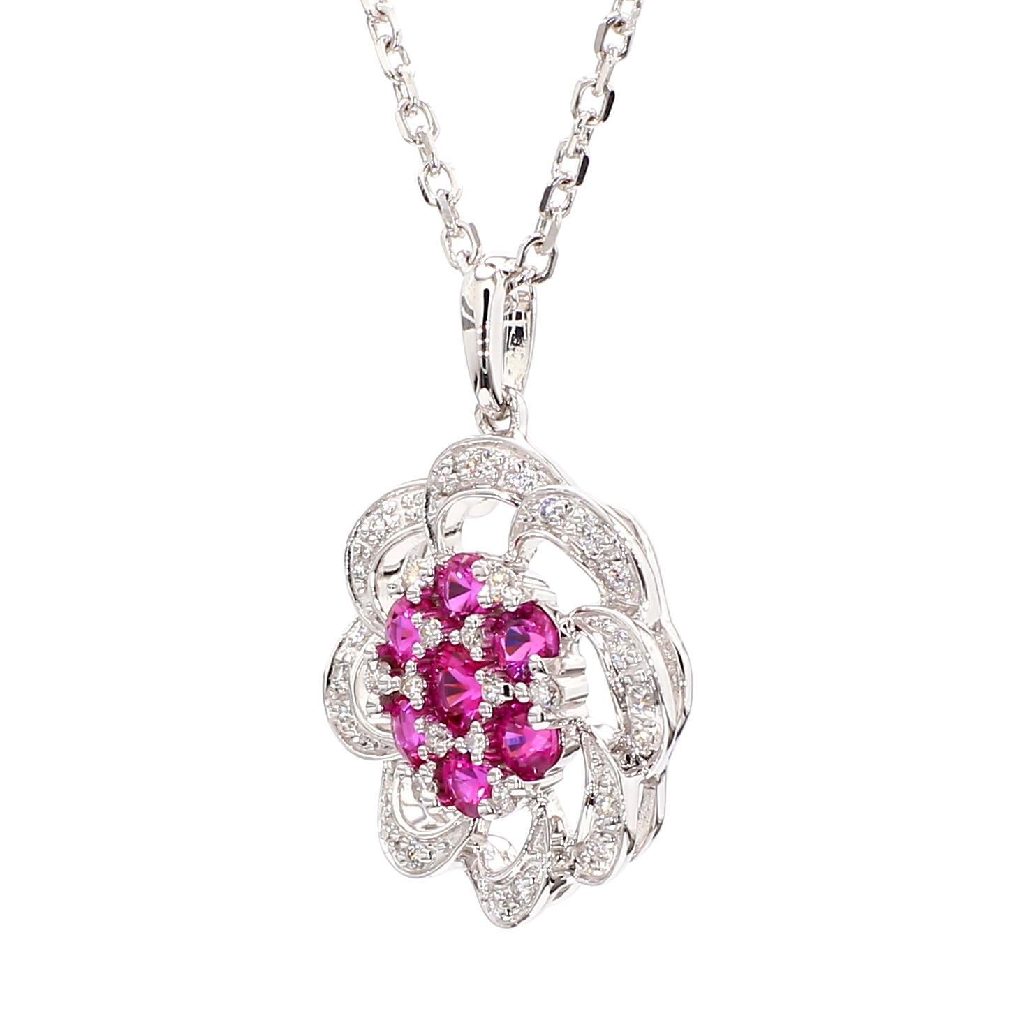 RareGemWorld's intriguing ruby pendant. Mounted in a beautiful 14K White Gold setting with natural round cut red ruby's. The ruby's are surrounded by natural round cut white diamond melee. This pendant is guaranteed to impress and enhance your