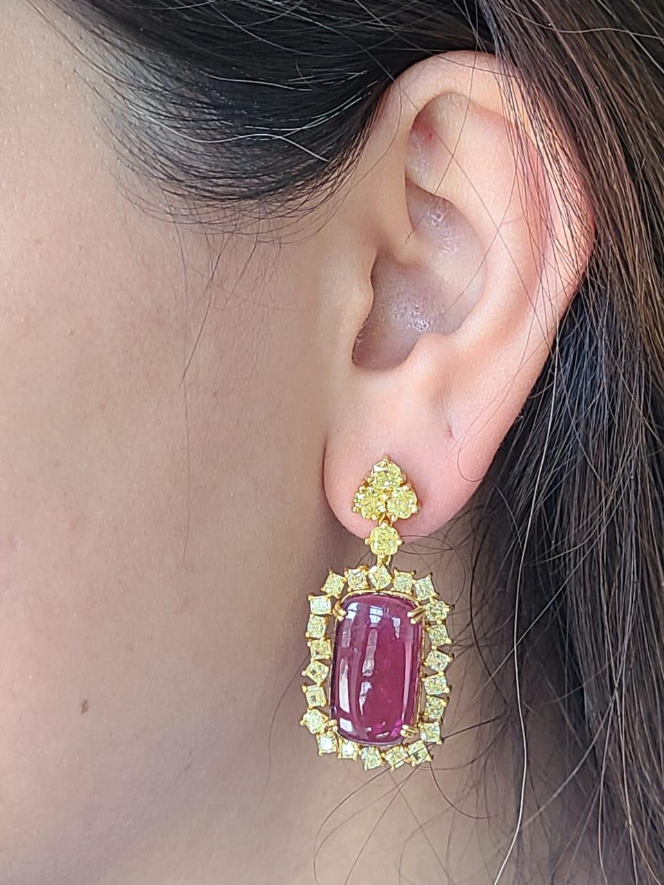 A very gorgeous and one of a kind, Rubellite Dangle Earrings set in 18K Yellow Gold & Diamonds. The weight of the Rubellite pair is 23.52 carats. The weight of the natural Yellow Diamonds is 5.20 carats. Net Gold weight is 11.26 grams. The