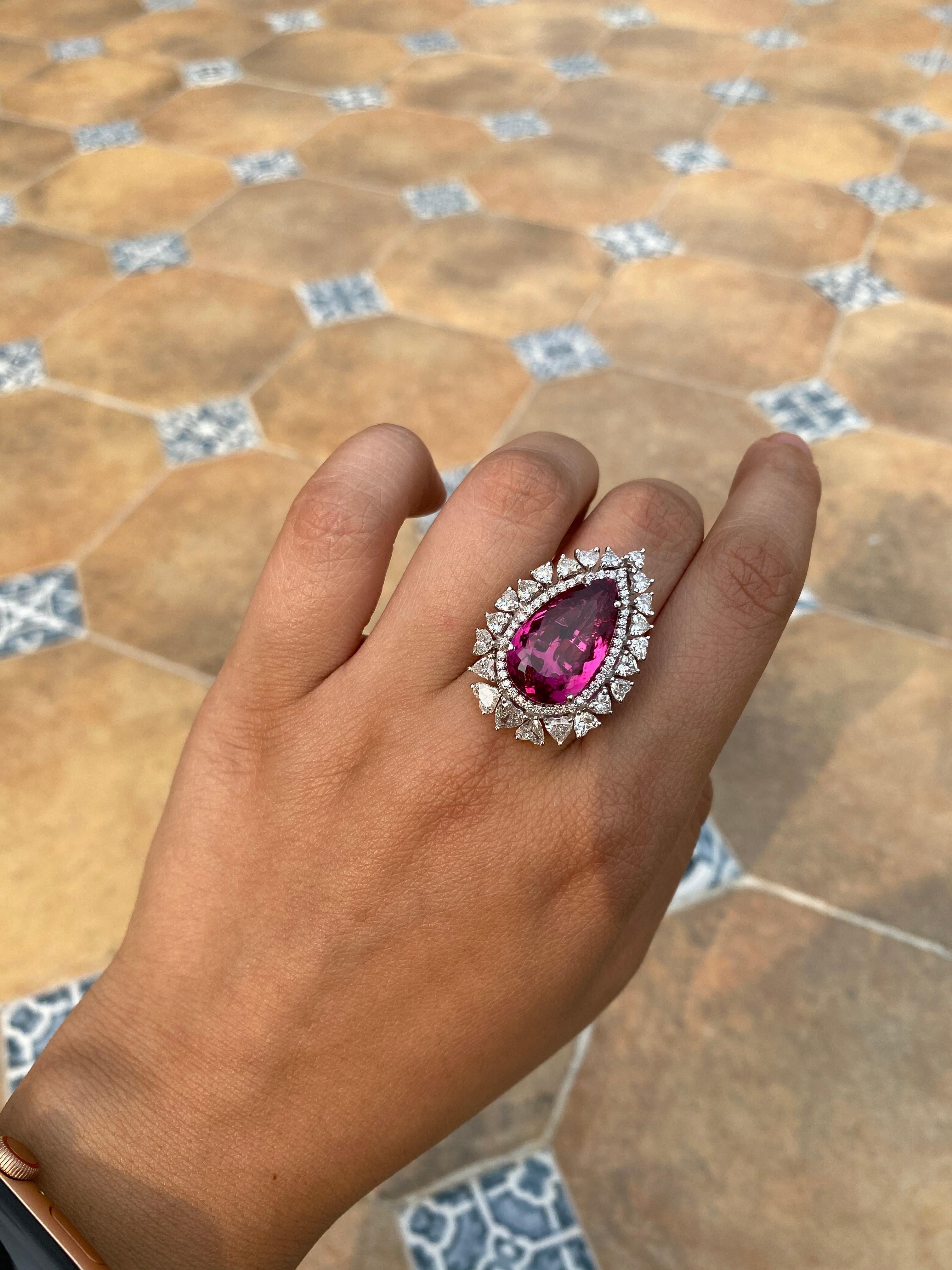 A gorgeous and Chic ring set in 18k white gold with Rubellite and heart shape diamonds. The high quality rubellite weight is 12.69 carats and diamond combined weight is 2.28 carats. The ring dimensions in cm 3.2 x 2.3 x 2.7 (LXWXH) . US size 6