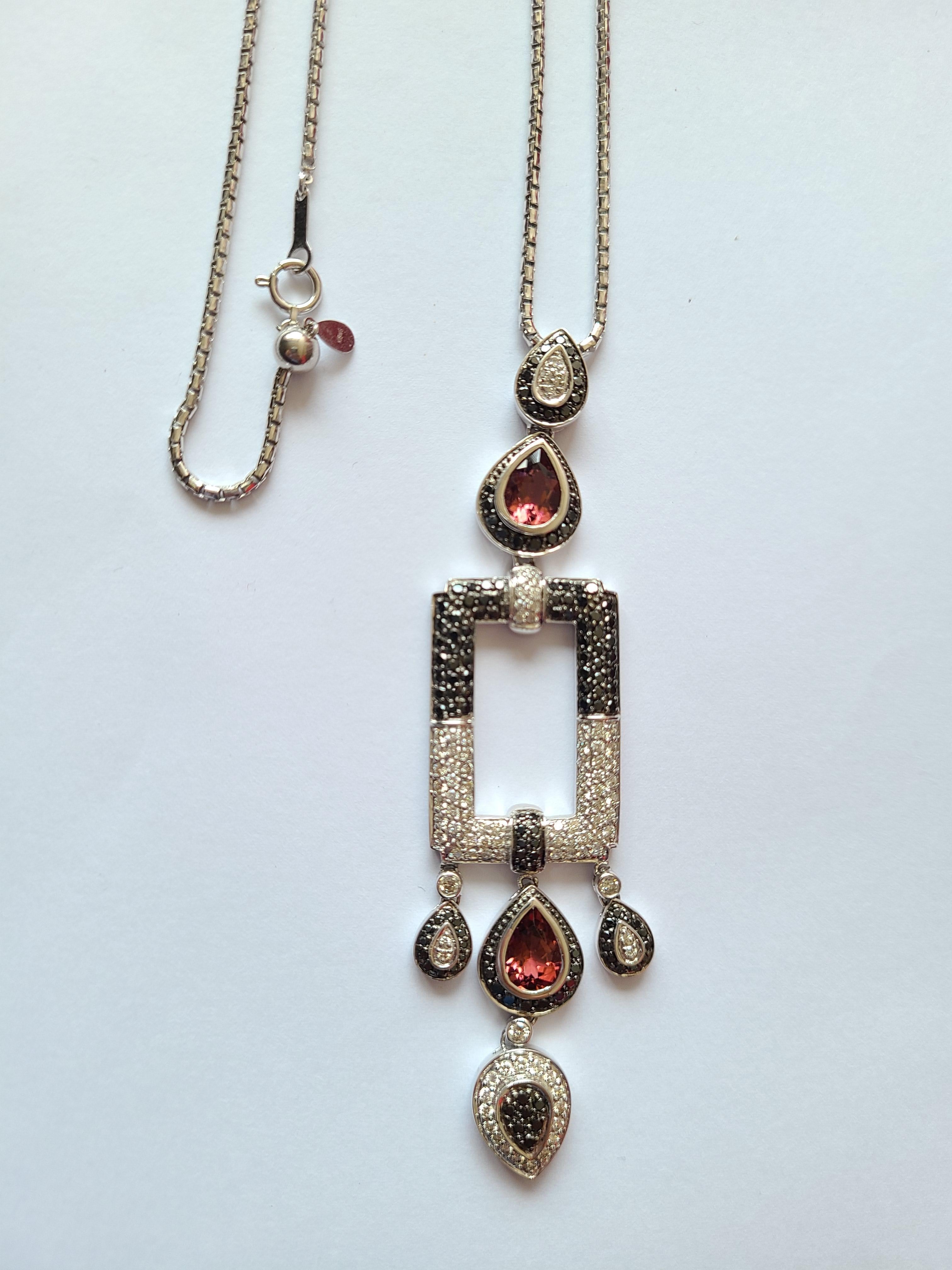 A beautiful and stylish art deco style pendant in 18k gold with rubellite and a mix of black and white diamond. The diamond weight is 2.43 carats and rubellite weight is 2.50 carats. The Pendant length in cm at its maximum is 39 cm and is adjustable