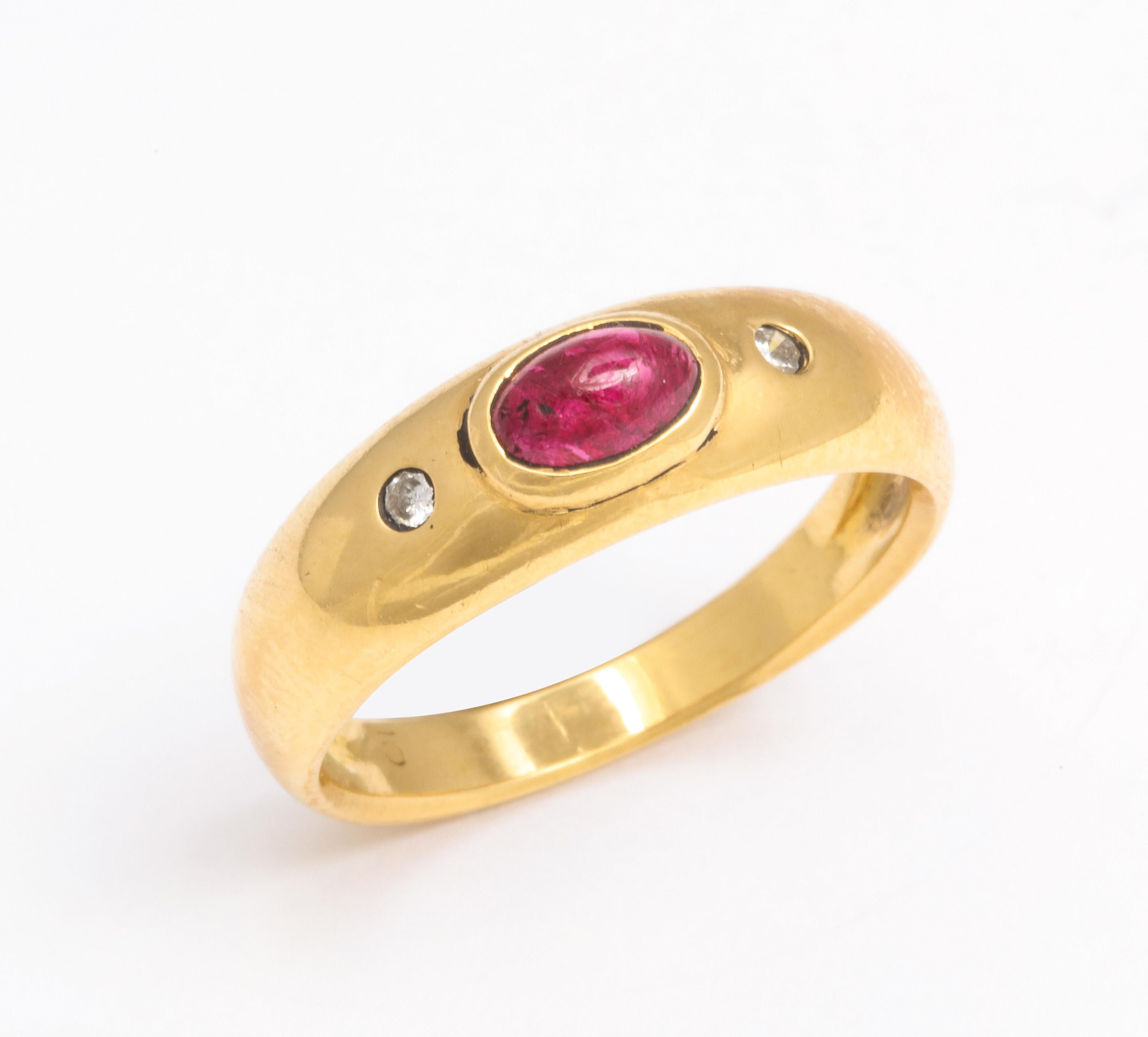 A fine cabochon ruby center stone with nice quality diamonds on each side.  This classic 18K Gypsy ring 
has flush mounted stones which is typical of the style ring.