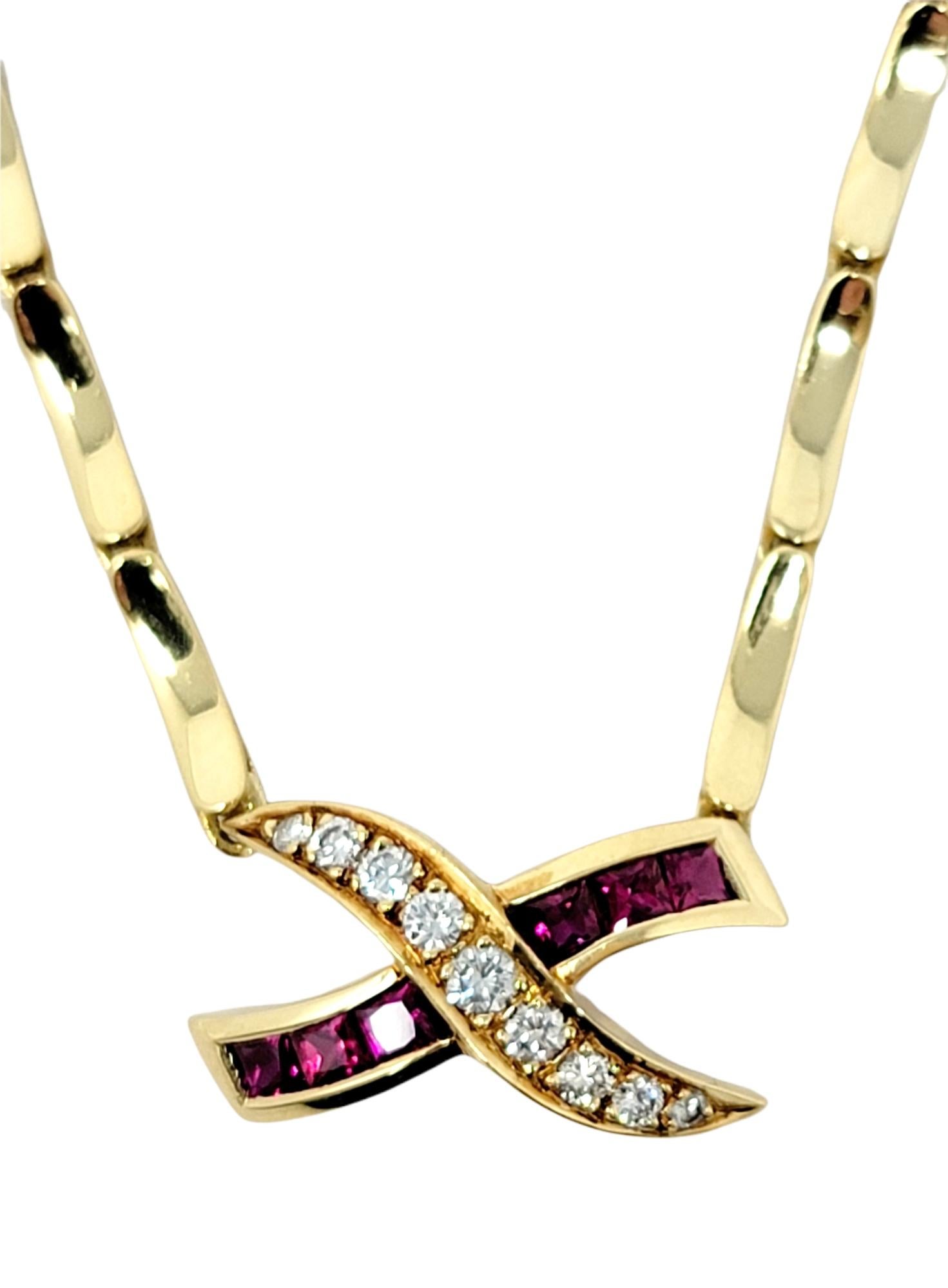 Elegant ruby and diamond 'X' pendant necklace set on a unique curved bar link chain in 18 karat yellow gold. The modern design gently hugs the neck and offers a subtle hint of color. 

Metal: 18K Yellow Gold
Natural Diamonds: .22 ctw
Diamond cut: