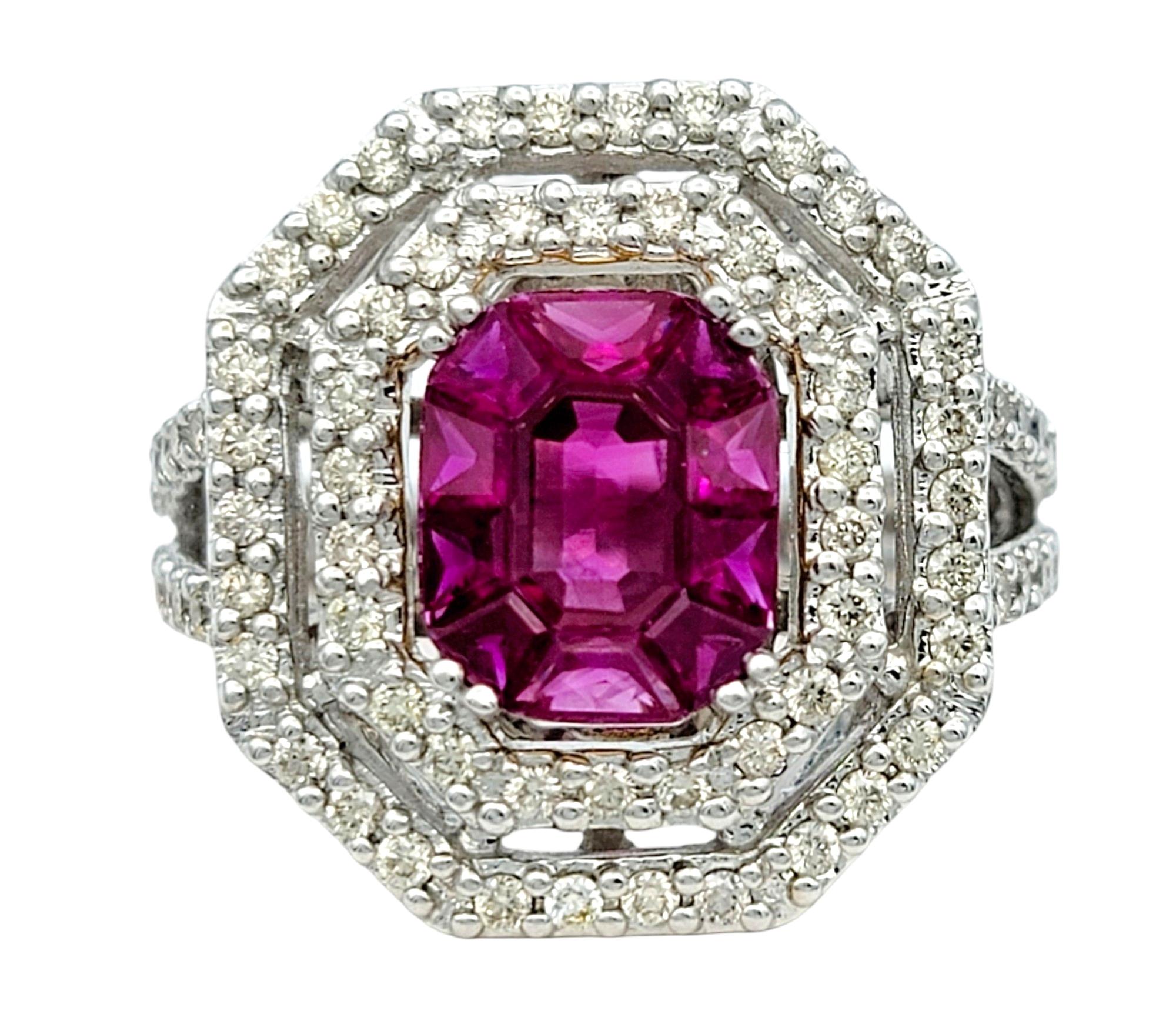 Ring Size: 7

This exquisite 18 karat white gold cocktail ring features a captivating emerald-cut ruby as its centerpiece, surrounded by 10 additional trapezoid cut rubies, creating the illusion of one large vibrant stone. Surrounding the bold