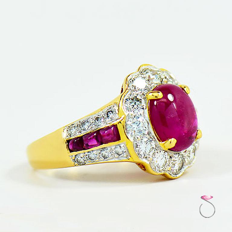 This Majestic natural Ruby ring with diamond halo is a real show stopper. Featuring a 2.42 carat rich red oval cabochon Ruby that scream with passion. The center ruby is set in four prongs surrounded by a diamond halo of 12 round brilliant diamonds.