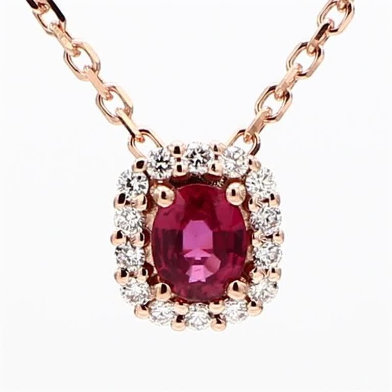 RareGemWorld's classic ruby pendant. Mounted in a beautiful 14K Rose Gold setting with a natural oval cut red ruby. The ruby is surrounded by natural round cut white diamond melee. This pendant is guaranteed to impress and enhance your personal
