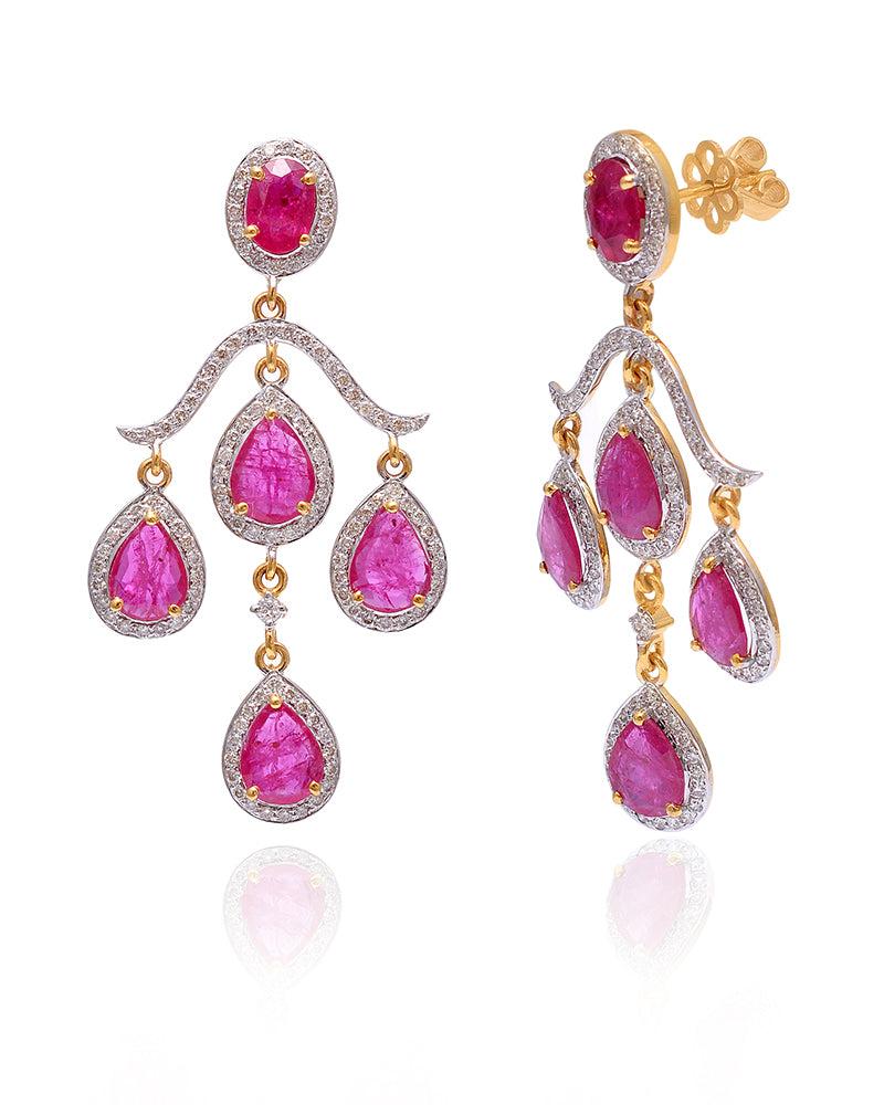 Drop design ruby gemstone dangle earrings in 14k yellow Gold and diamonds. The earrings are designed to dangle, and are perfect for any occasion.

Specifications

Dimensions: 48*23 MM
Gross Weight: 8.54 gms
Gold Weight: 6.64 gms
Gold Purity: 14K