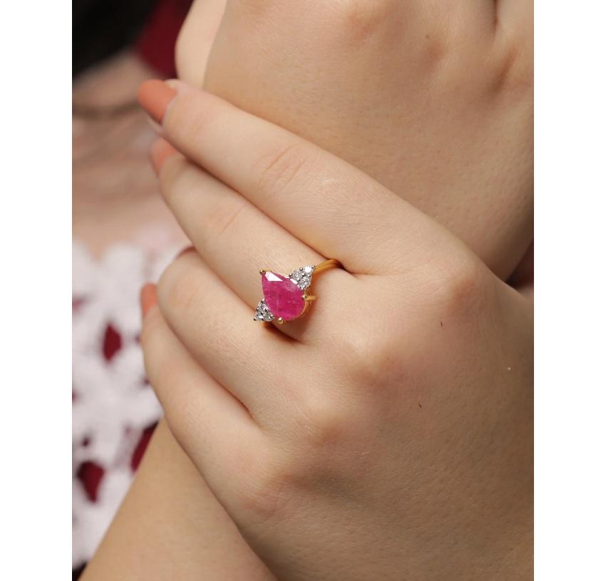 Pink and Pleasing! Made with 0.20 Carat Natural Diamond (G-H Color, SI1-SI2 Purity) in 14K Solid Yellow Gold with chiseled Ruby Natural Gemstone. The ring has high quality enamelling and a sheen design that surpasses mundanity. Triangular placement