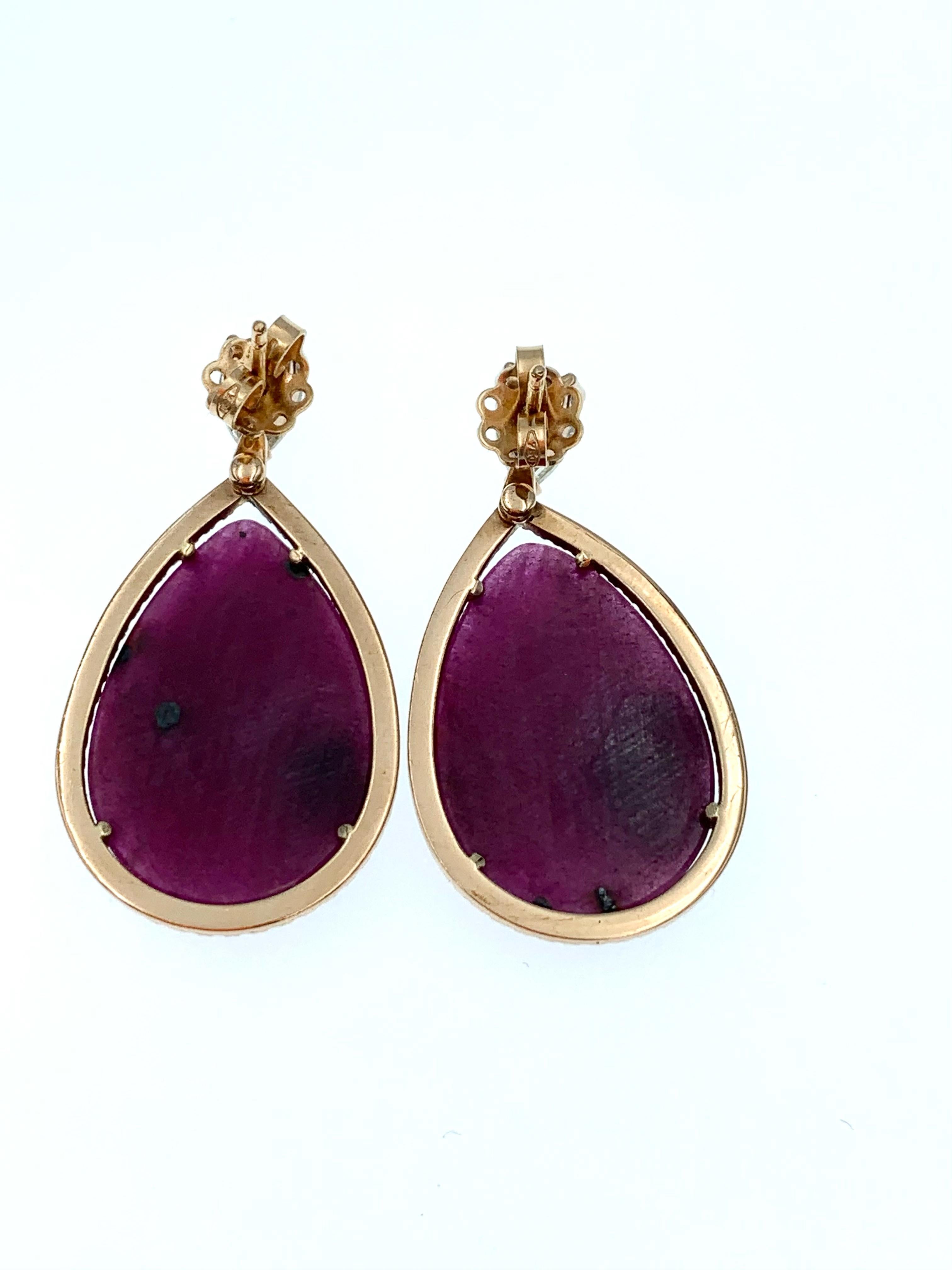 Hand made in 9 karat Rose Gold these pear shaped natural Ruby slices with a weight of approximately 36 carats in total are surrounded by a halo of black diamonds, hanging off a set of champagne coloured diamonds, approximately 1.20 carats in total.
