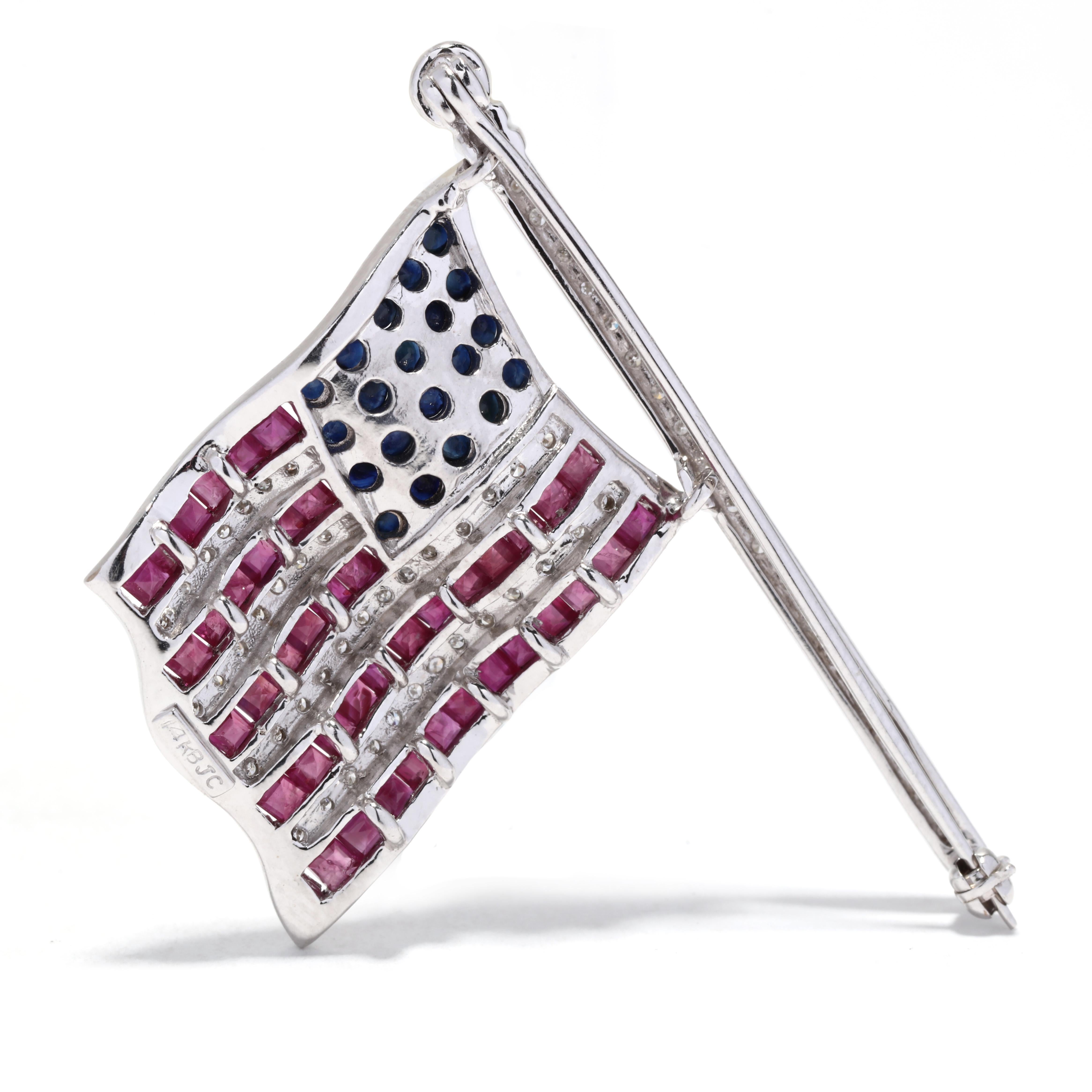 This exquisite 14K white gold American Flag brooch is the perfect way to show your patriotism. Featuring 2.5ctw of natural rubies, sapphires, and diamonds, this intricate and articulate design measures 1 5/8 inches long and is sure to be a