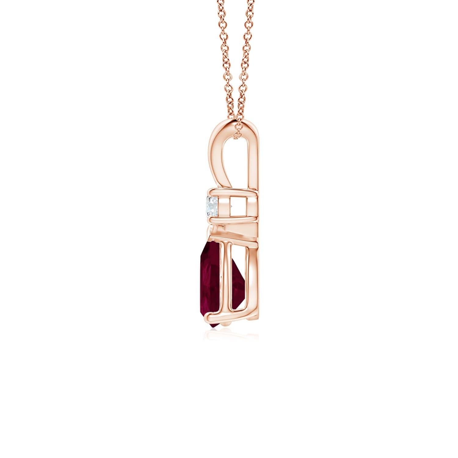 This classic solitaire pendant features a pear-shaped ruby secured in a prong setting. A brilliant round diamond sits atop the purplish red gemstone. Simple yet alluring, this ruby pendant in 14k rose gold is crafted with a lustrous v-bale.