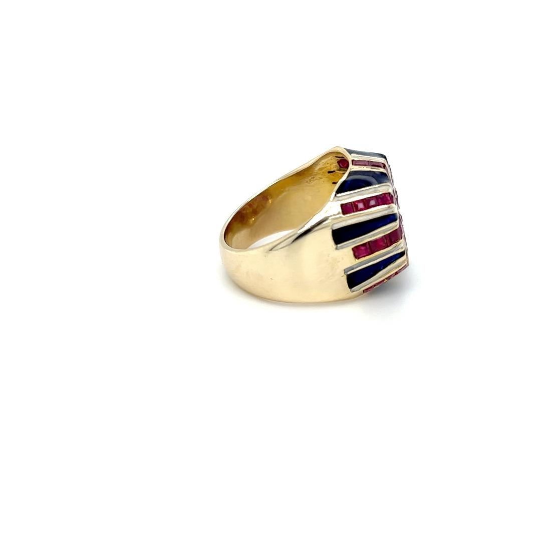 One 14 karat yellow gold Union Jack design ring set with forty-four (44) calibrated square cut natural rubies and blue and white enamel. The ring is stamped 