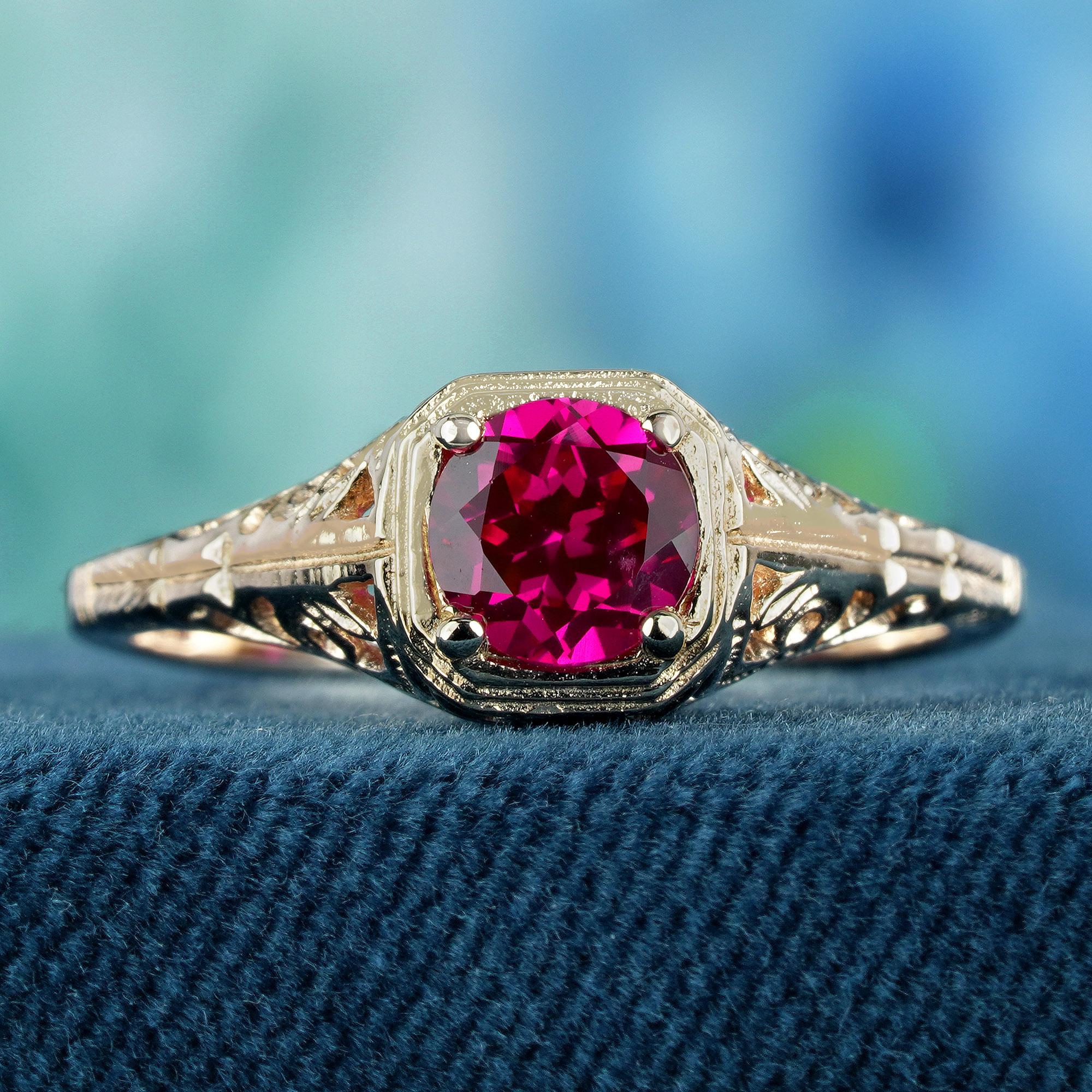 Behold a timeless treasure from a bygone era. Our exquisite ring glimmers with the ethereal allure of a natural ruby, its faceted surface capturing light and radiating an inner luminescence. Delicately encircled by a web of filigree dancing across