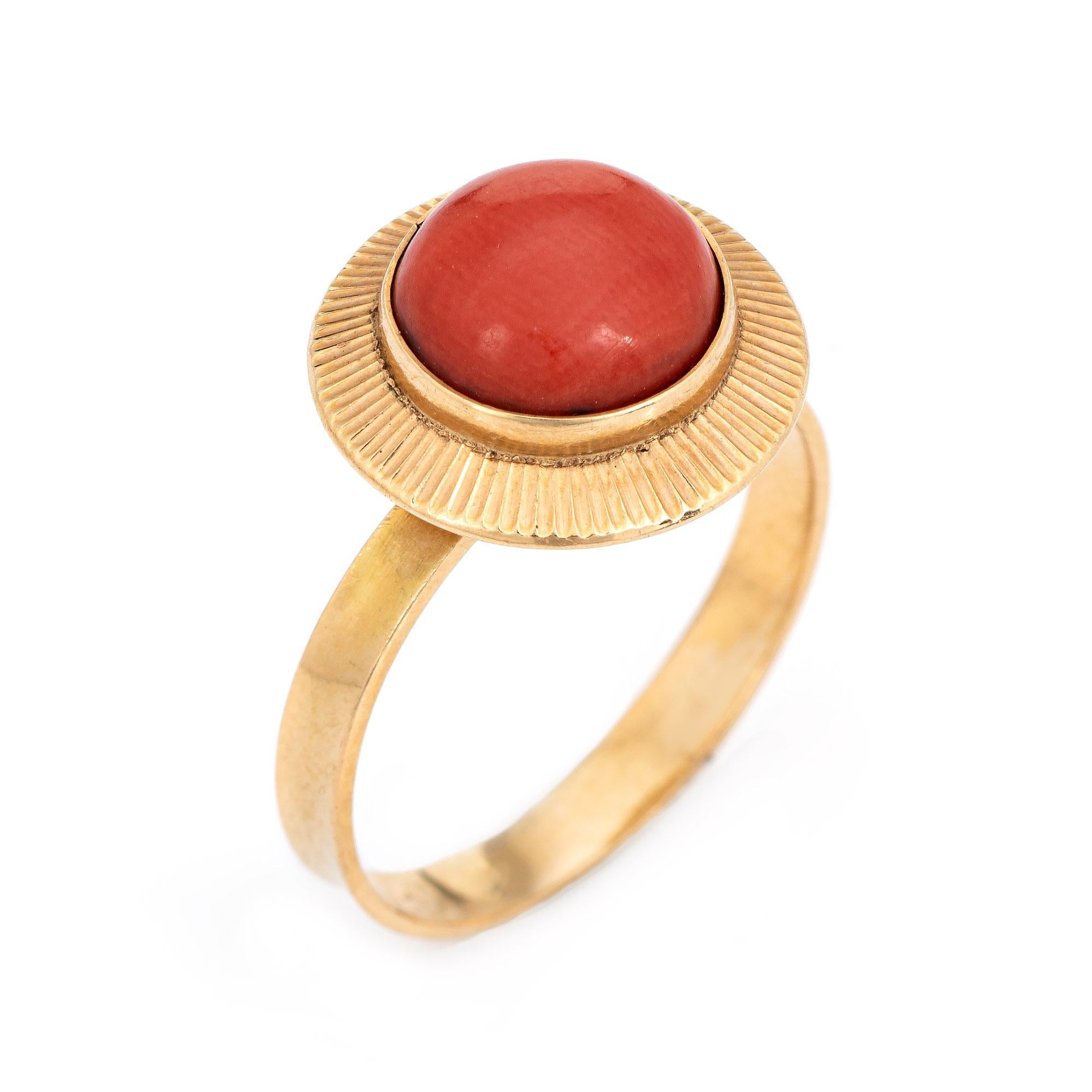 Stylish vintage natural salmon coral ring (circa 1950s to 1960s) crafted in 18 karat yellow gold. 

Cabochon cut coral measures 8mm diameter (estimated at 2 carats). The coral is in excellent condition and free of cracks or chips. 

The salmon hued