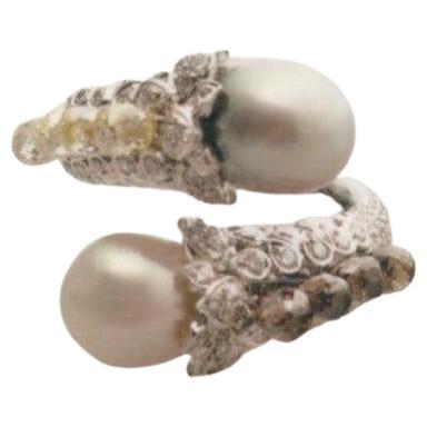 The natural saltwater pearl takes center stage, exuding timeless beauty and elegance. Its lustrous surface and unique iridescence make it a truly captivating feature of this cocktail ring.

Surrounding the natural saltwater pearl are dazzling