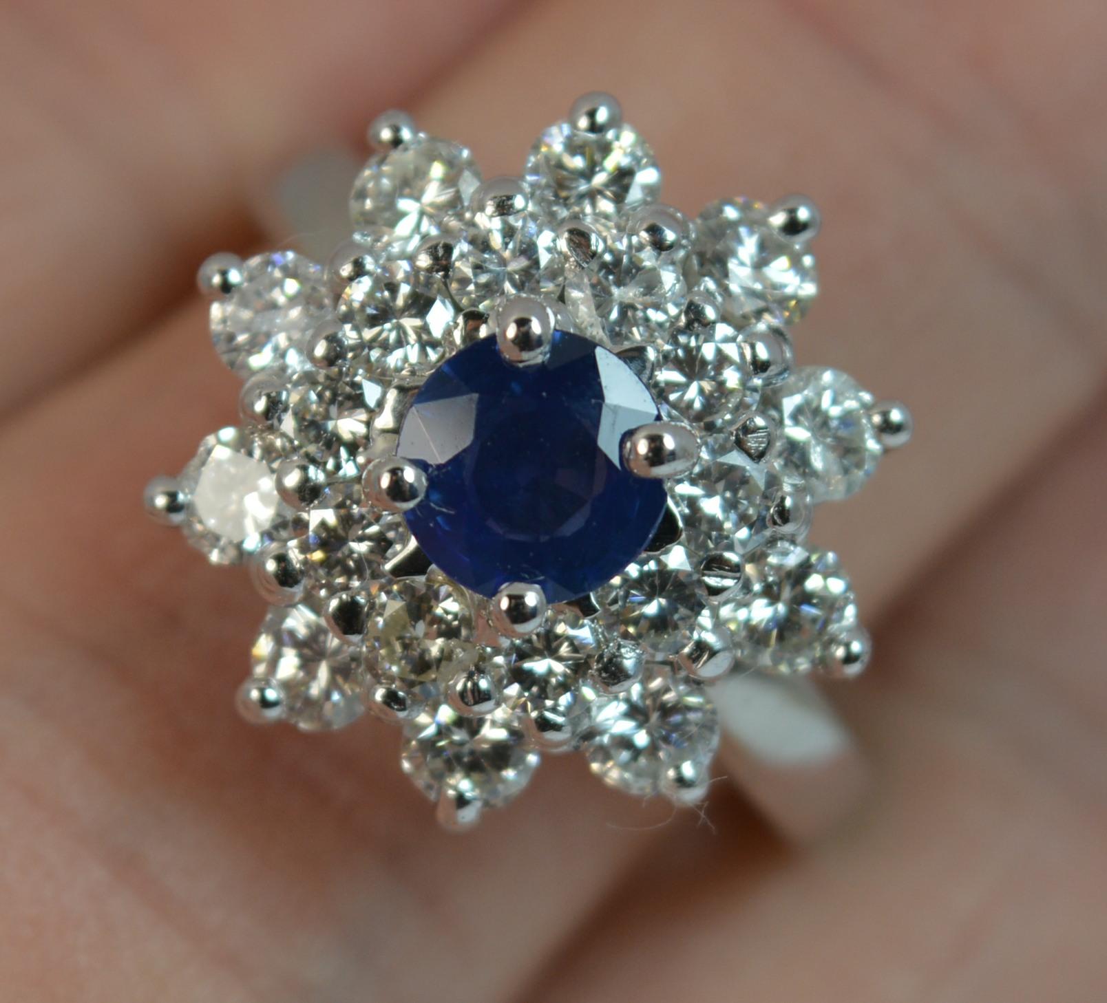 A stunning and superb quality Sapphire and Diamond ring.
Ring Size; O 1/2 UK, 7 1/2 US
Designed with a round cut sapphire to the centre in four claw setting, 5.9mm diameter.

Surrounding are two tiers of round brilliant cut diamonds of two sizes.