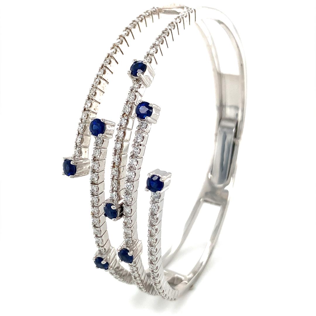 Natural 1.20 Carat Blue Sapphire and 1.20 Carat VS Quality Diamond Bangle set in 18 Kt white gold. 

