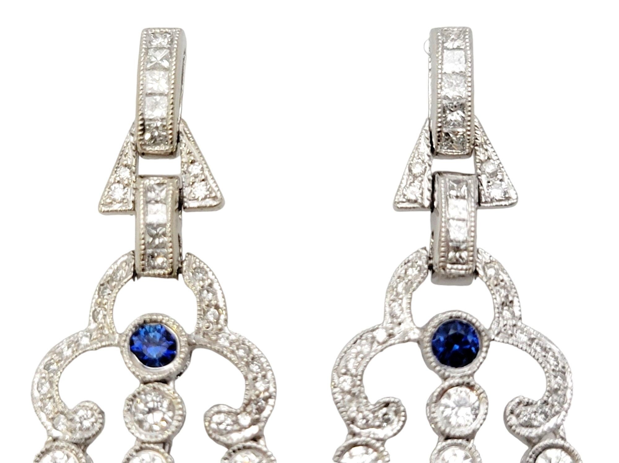 Discover the epitome of elegance with these captivating chandelier dangle earrings, exquisitely crafted in 14 karat white gold. A testament to timeless beauty, these earrings boast a delightful combination of natural sapphires and diamonds, sure to