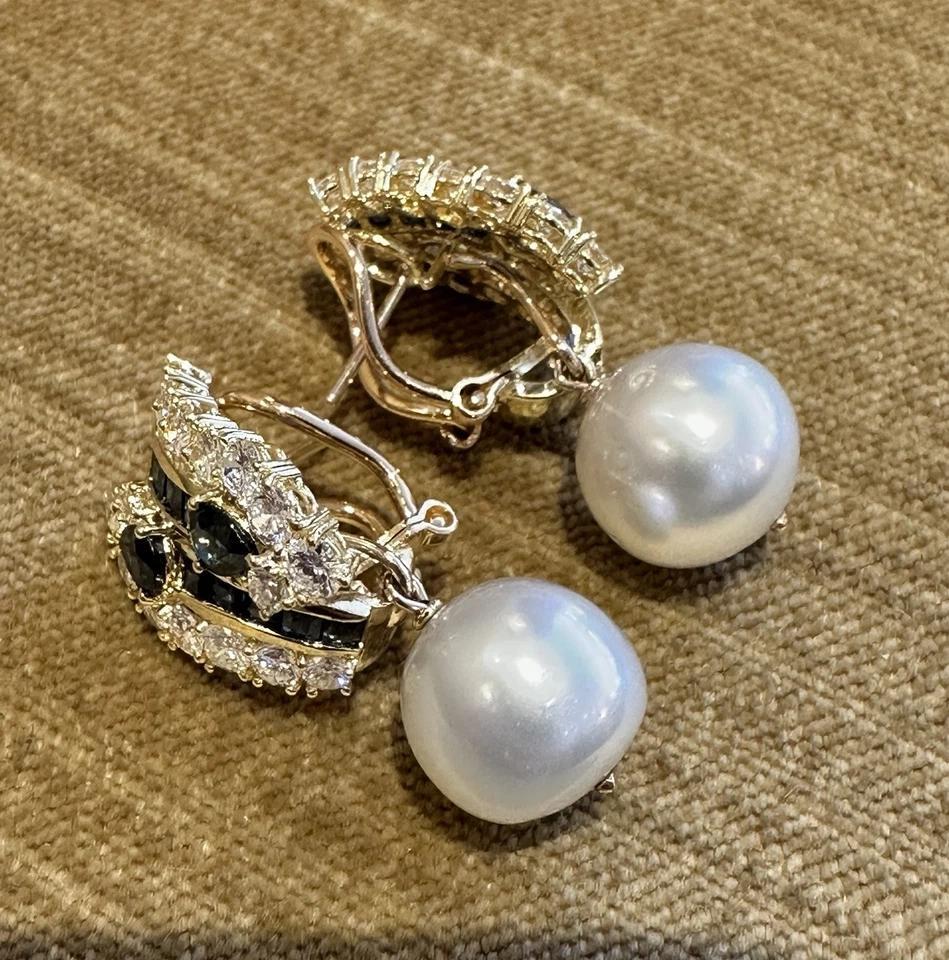 Natural Sapphire and Diamond Earring with Pearl Drop in 18k Yellow Gold

Sapphire, Pearl and Diamond Earrings feature Pear shape and Baguette Sapphires and Round Brilliant Diamonds in a crossover design with 12.3 mm White Pearls, all set in 18k