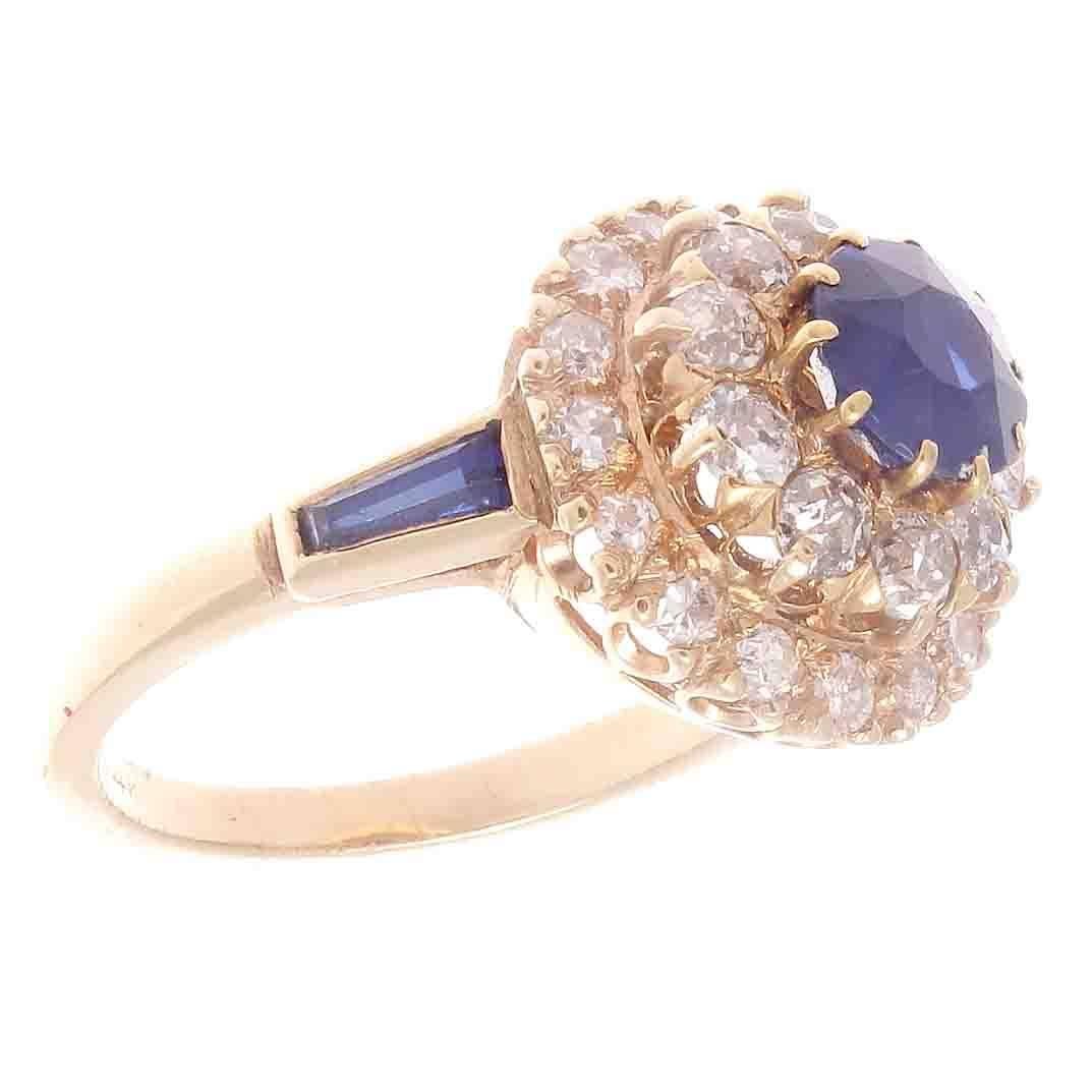 Colorful and elegant. Featuring an approximately 0.75 carat natural royal blue sapphire uplifted by ascending layers of near colorless diamonds.  Crafted in 14k yellow gold embedded with unique baguette cut sapphires bezel set in the ring. 

Ring