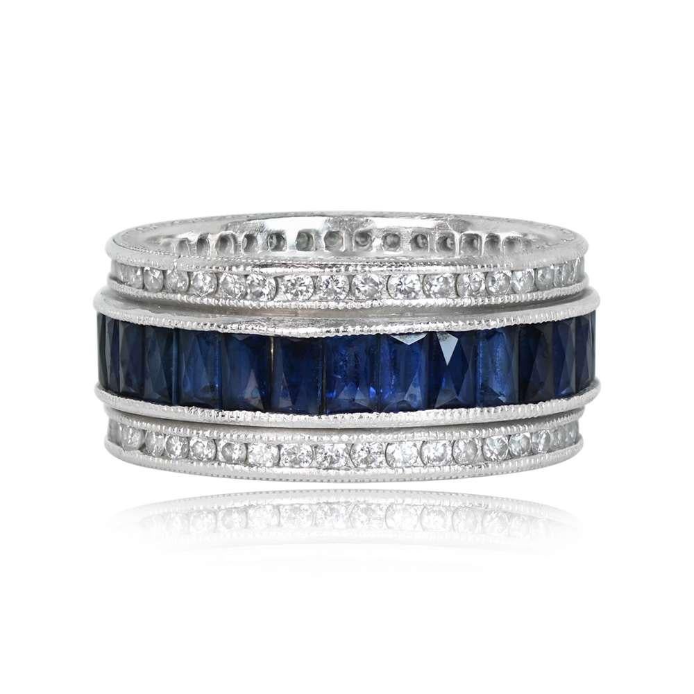 An enchanting eternity band showcasing channel-set elongated French-cut natural sapphires. Rows of channel-set round brilliant diamonds elegantly border the sapphires, creating a captivating design with stones set both above and below. Crafted in