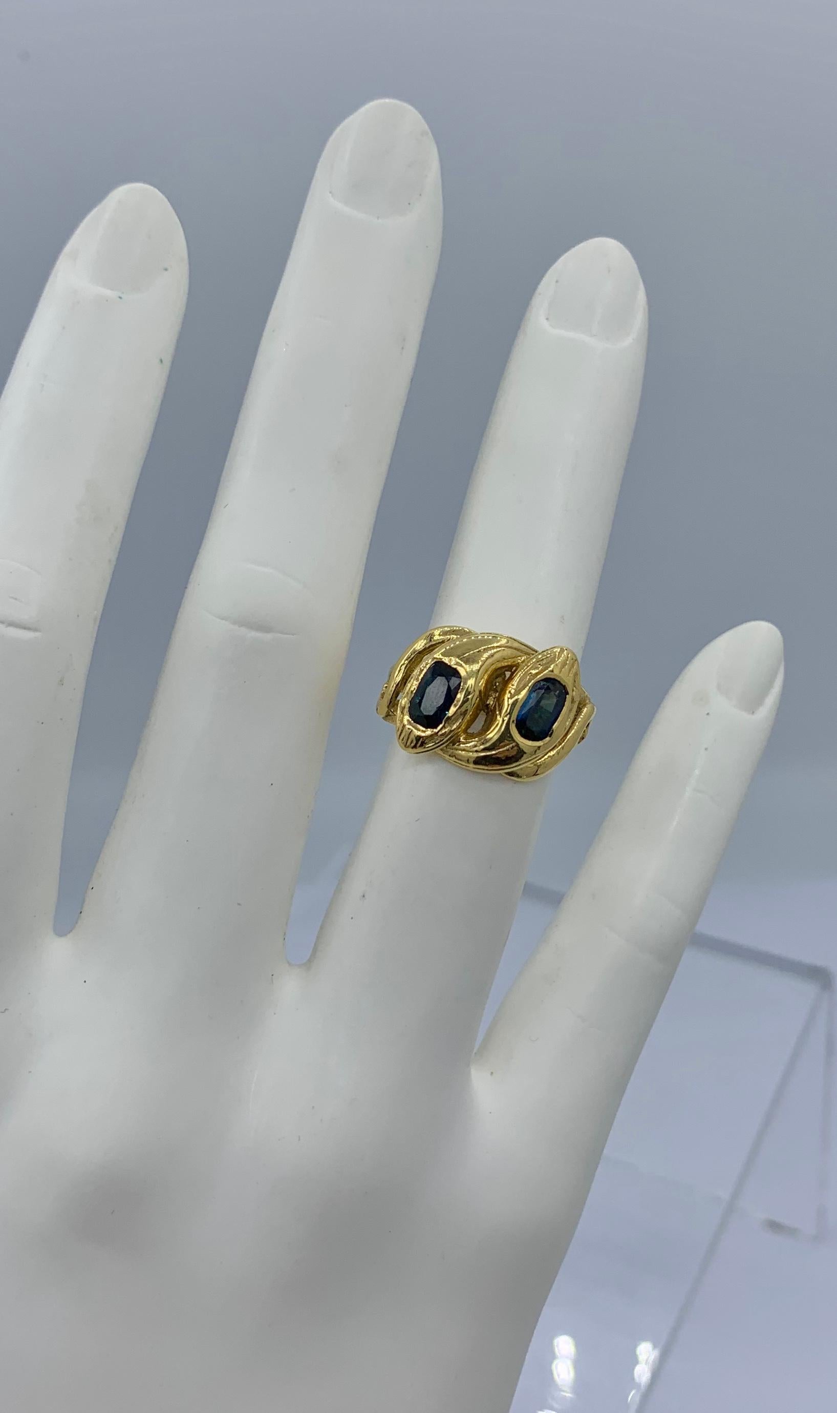 THIS IS A WONDERFUL ANTIQUE ART NOUVEAU - VICTORIAN - BELLE EPOQUE - ENTWINED SNAKE RING WITH TWO SPECTACULAR NATURAL UNTREATED FINE BLUE SAPPHIRE SET HEADS.  THE RING HAS FRENCH HALLMARKS AND IS 18 KARAT YELLOW GOLD.  THE SNAKE RING WITH THE