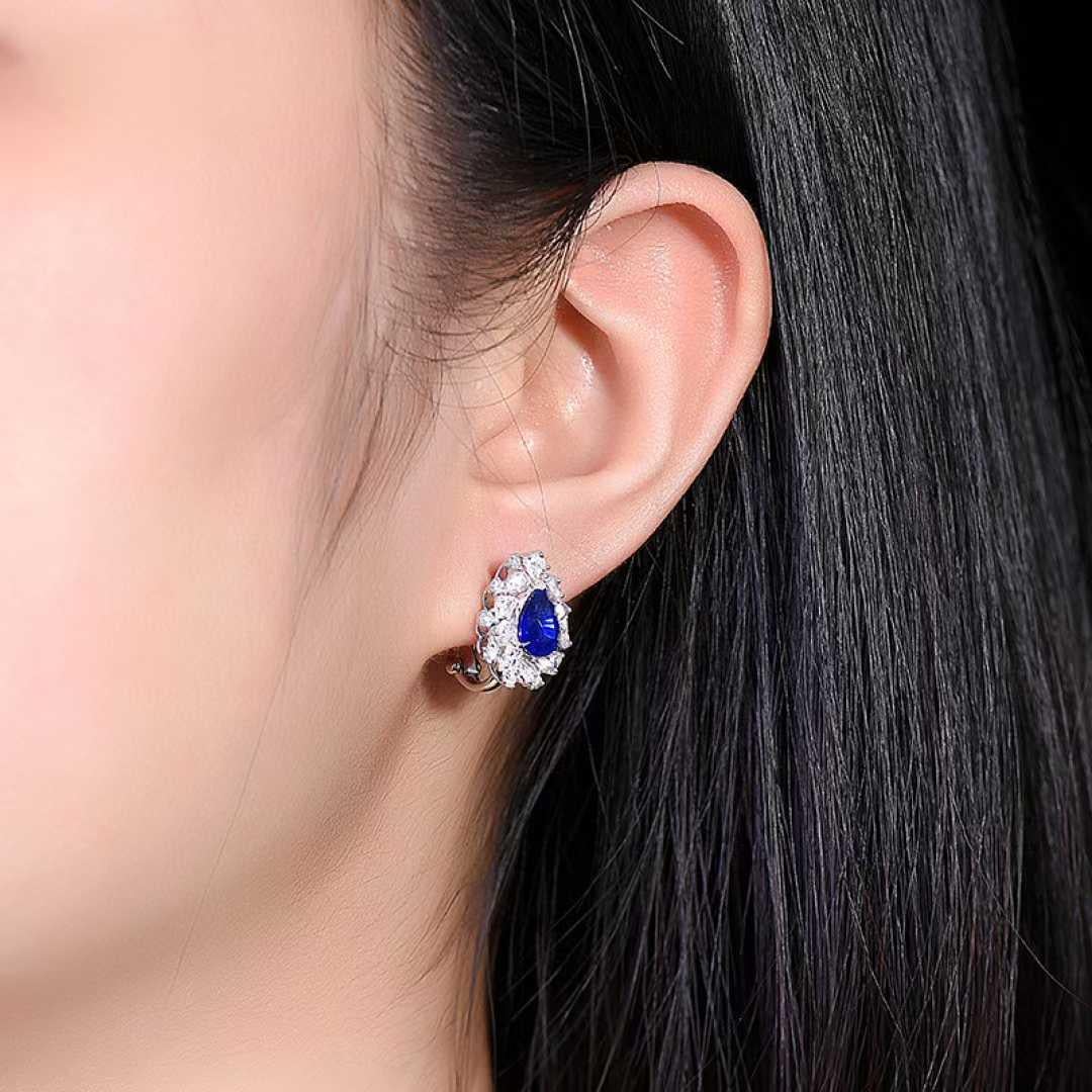 Elegance meets timeless beauty in these exquisite stud earrings, featuring natural sapphires totaling 3.20 carats. Each blue sapphire is set in lustrous 18K white gold and surrounded by a sparkling halo of white diamonds, adding an extra 1.00 carat
