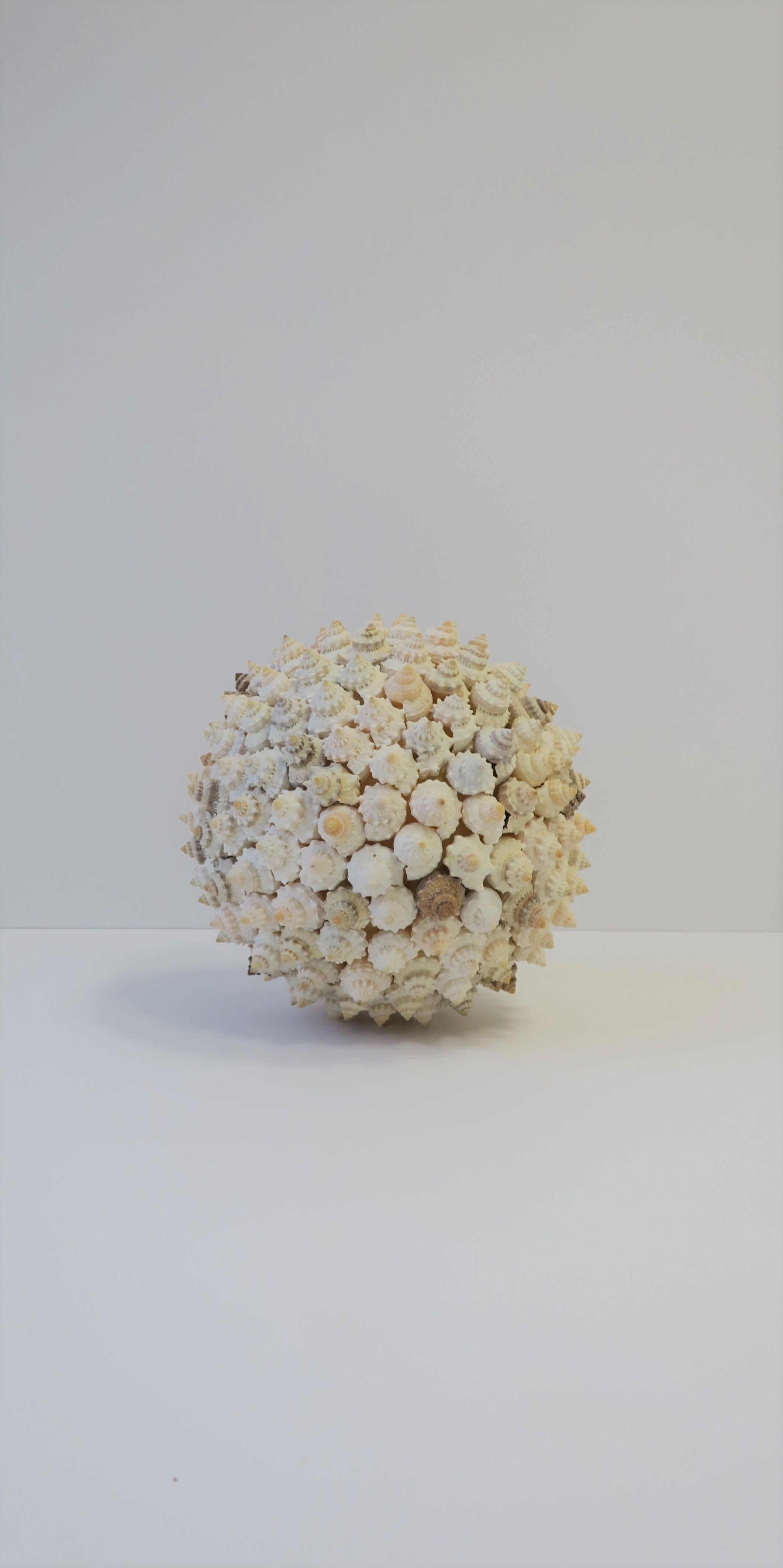A very beautiful natural seashell ball sphere round natural organic modern style sculpture piece. Piece is made from small conch seashells. Seashell sculpture measures: 10
