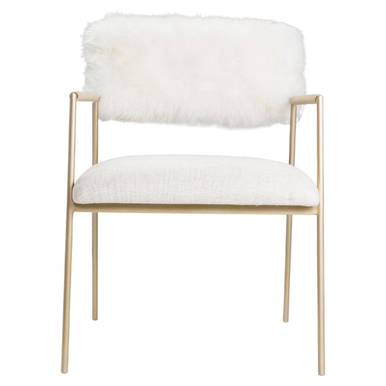 Dramatic and bold, the Apollo armchair with Golden base metal is a trendy addition your dinning room, bedroom, desk, or living space. The chair features a cream natural sheepskin backrest and gold metal legs.

Color customization is available upon