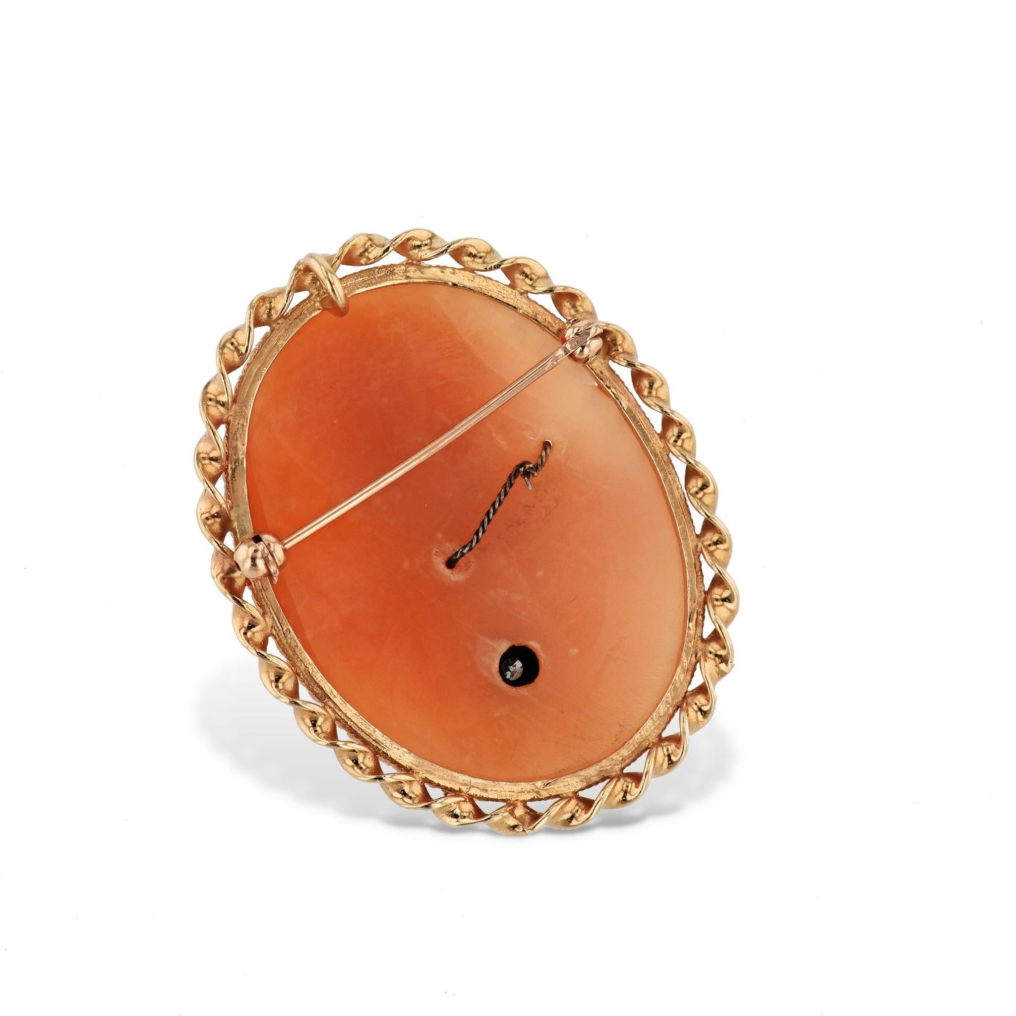 Capture the timeless beauty of this natural shell cameo pin, featuring an oval-shaped shell with a captivating profile of a portrait carved into 14kt yellow gold. Accented with one sparkling diamond. This distinctive estate piece from H&H's Estate &