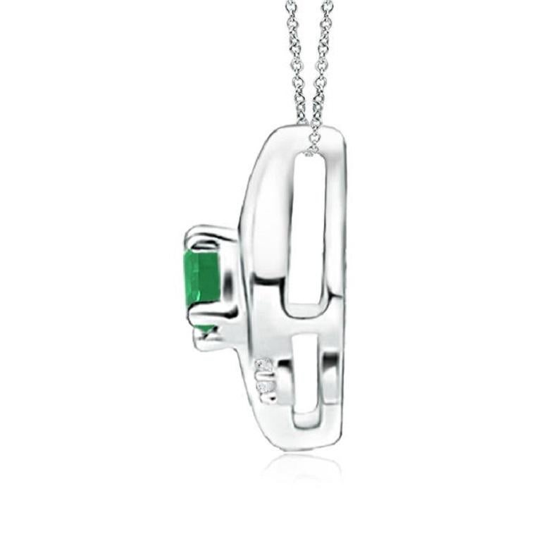 This gorgeous pendant features an alluring conch-like frame that holds a lush green emerald. Sparkling round diamond accents add to the overall allure of the design. This oval emerald and diamond pendant is designed in enduring 18k white gold.