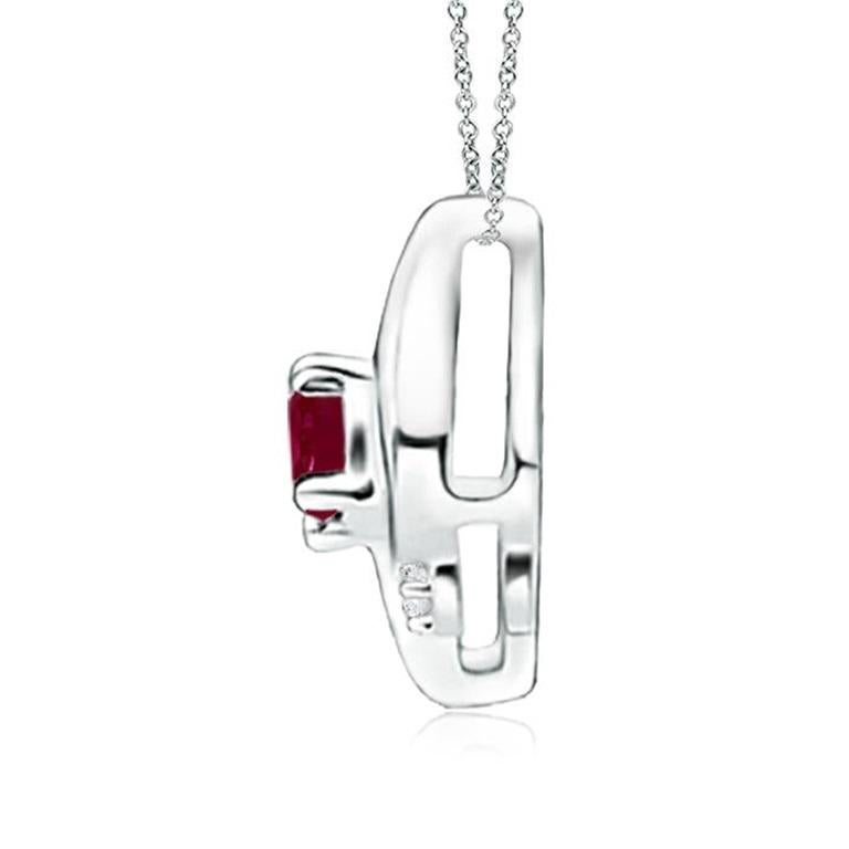This gorgeous ruby solitaire pendant features an alluring conch-like frame within which sits a prong set, purplish red ruby. Sparkling round diamond accents add to the overall allure of the design. This tilted oval ruby pendant is designed in