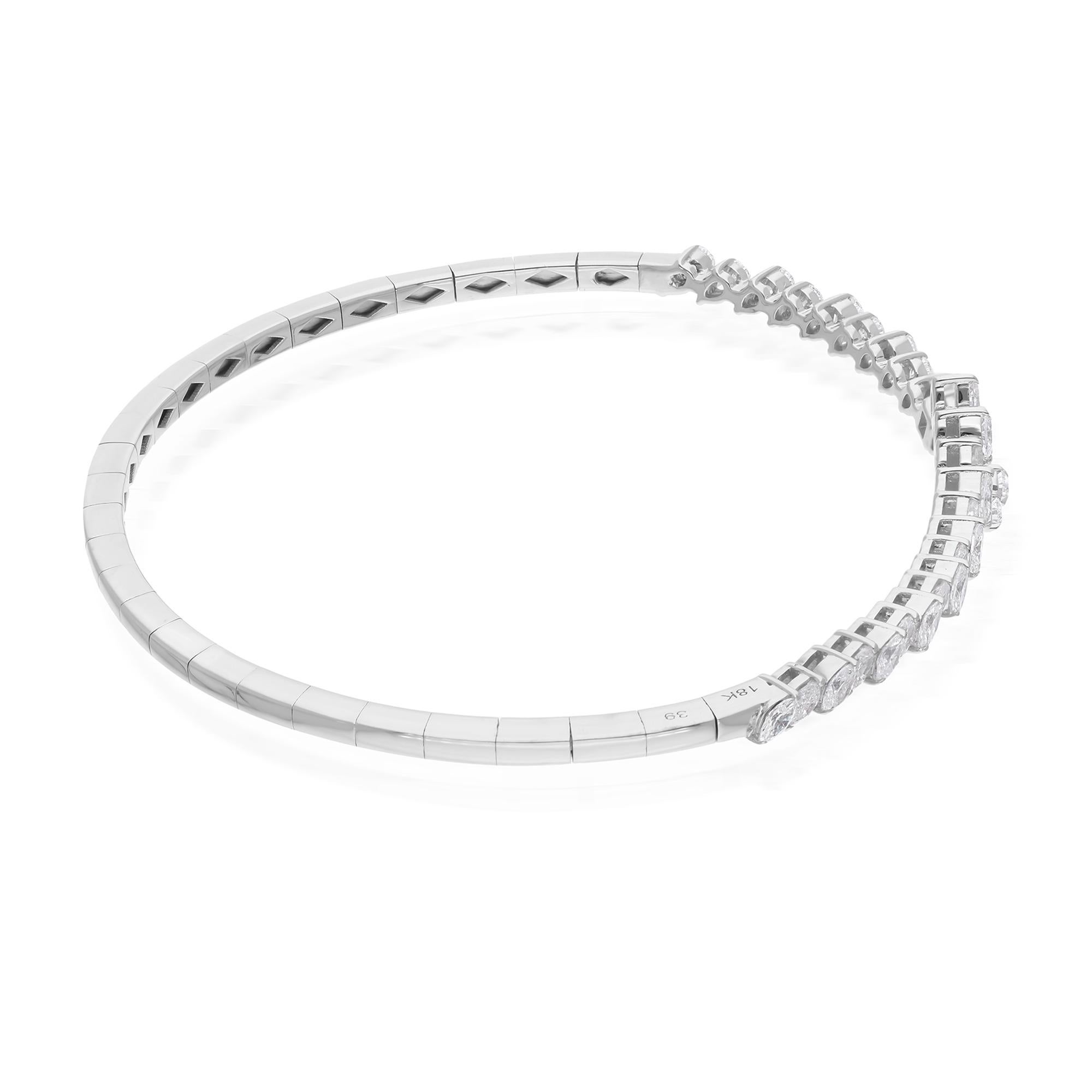 The enchanting diamonds are carefully set within the sleek contours of the cuff bangle, creating a striking contrast against the lustrous backdrop of 14 Karat White Gold. This precious metal not only provides a radiant sheen but also serves as a