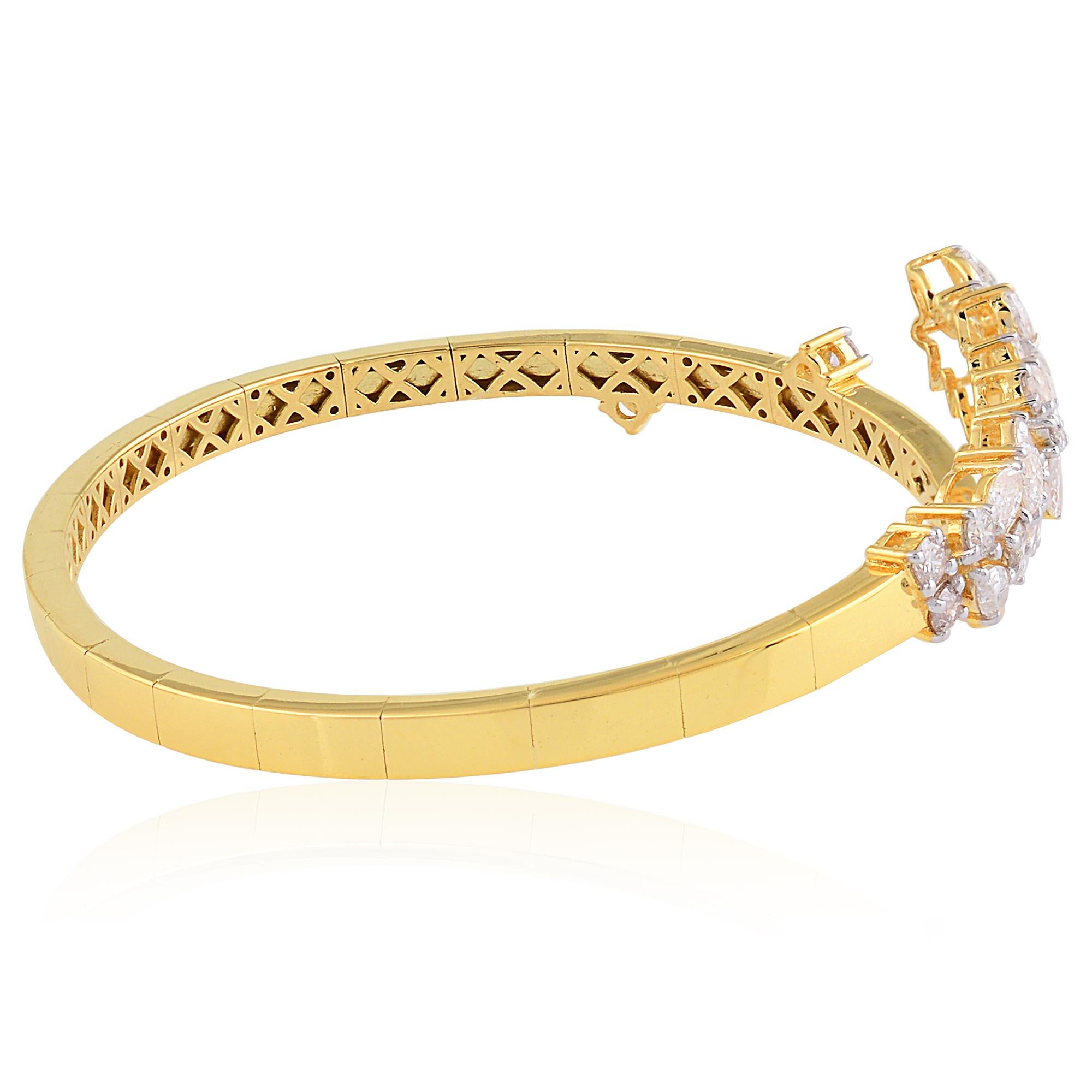 Crafted with exquisite attention to detail, this stunning cuff bangle bracelet showcases the timeless allure of natural diamonds set in lustrous 14 karat yellow gold. Each diamond, meticulously selected for its exceptional clarity and brilliance,