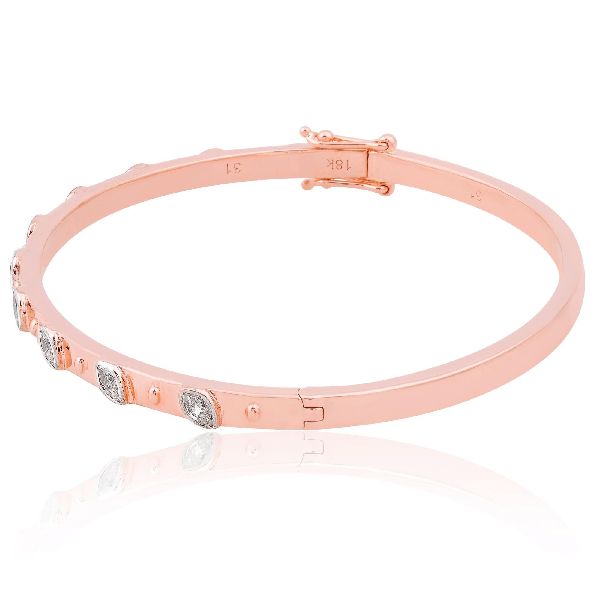 The bangle design of the bracelet adds a modern twist to its classic silhouette, with the sleek lines of the gold band elegantly complementing the brilliance of the diamonds. The open-ended design ensures a comfortable and secure fit, while also
